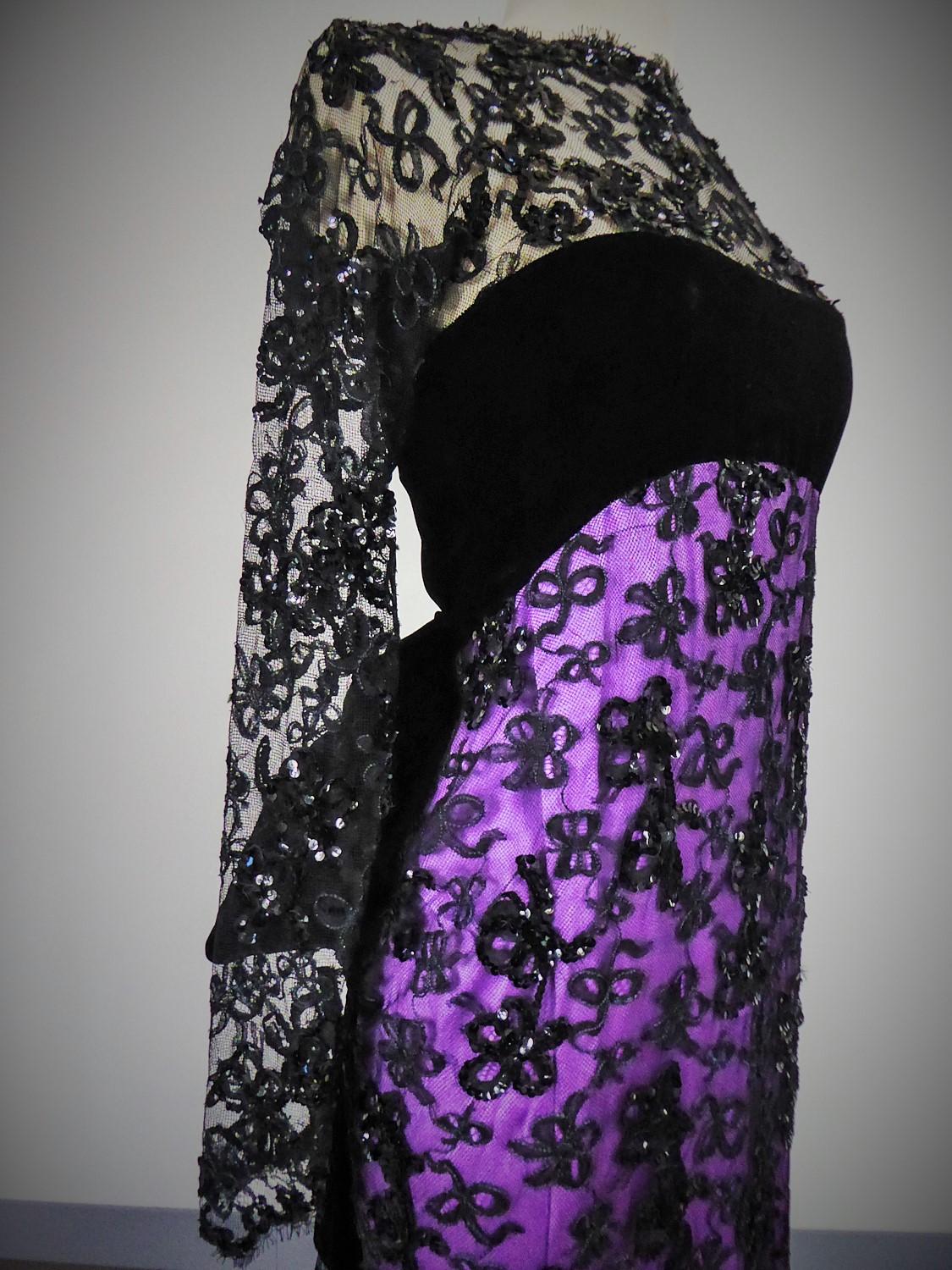 Fall Winter 1985 Collection
France
An exceptional Yves Saint Laurent Couture evening gown with train from the 1985  Collection. Purple satin from th the house designer Abraham covered with black Marescot lace entirely embroidered with black sequins.