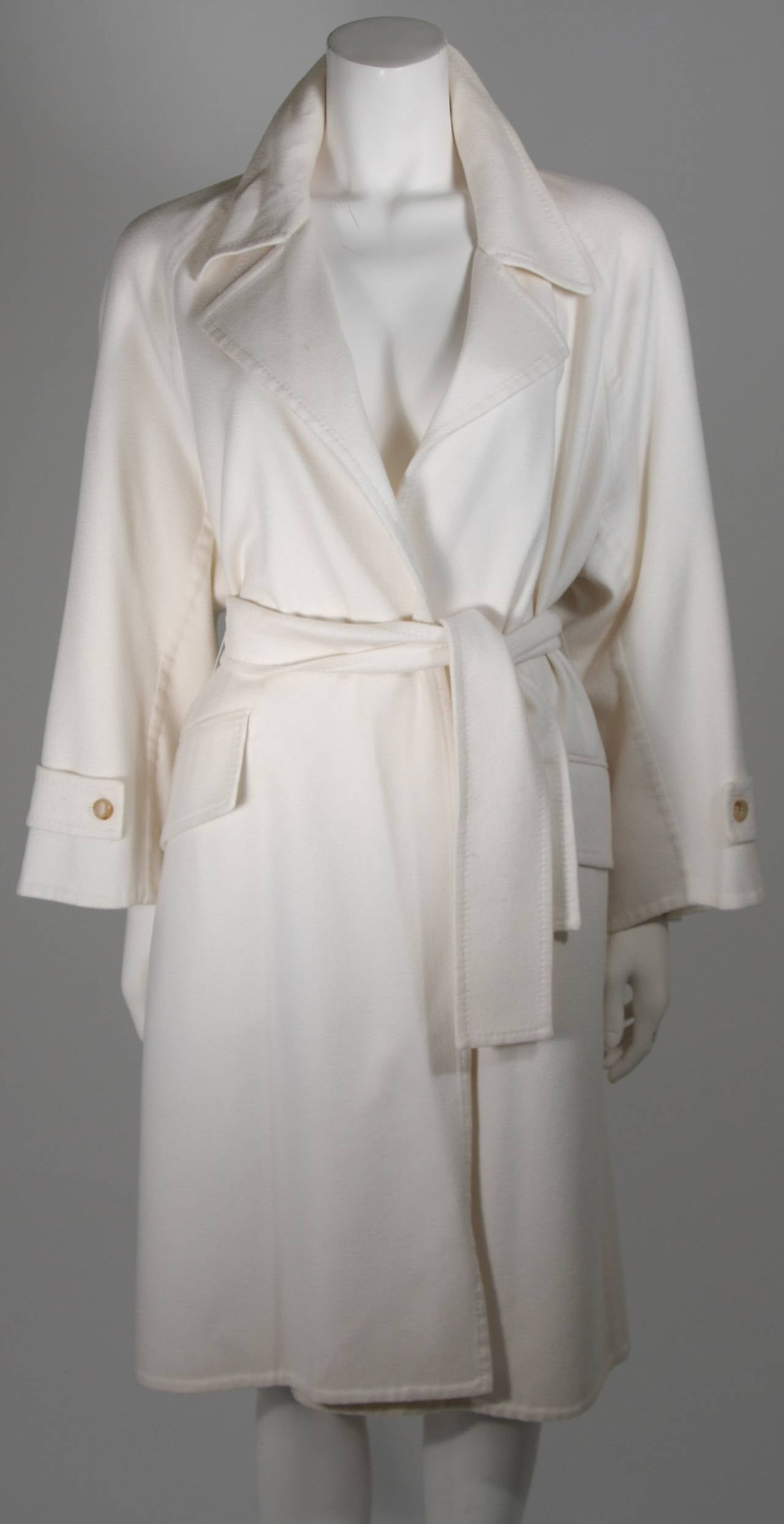 This coat is composed of an ultra supple cashmere in a beautiful brilliant shade of white. There are front pocket details and a belt closure. Excellent condition with original tag. Made in France.

Please feel to contact us with any inquiries you