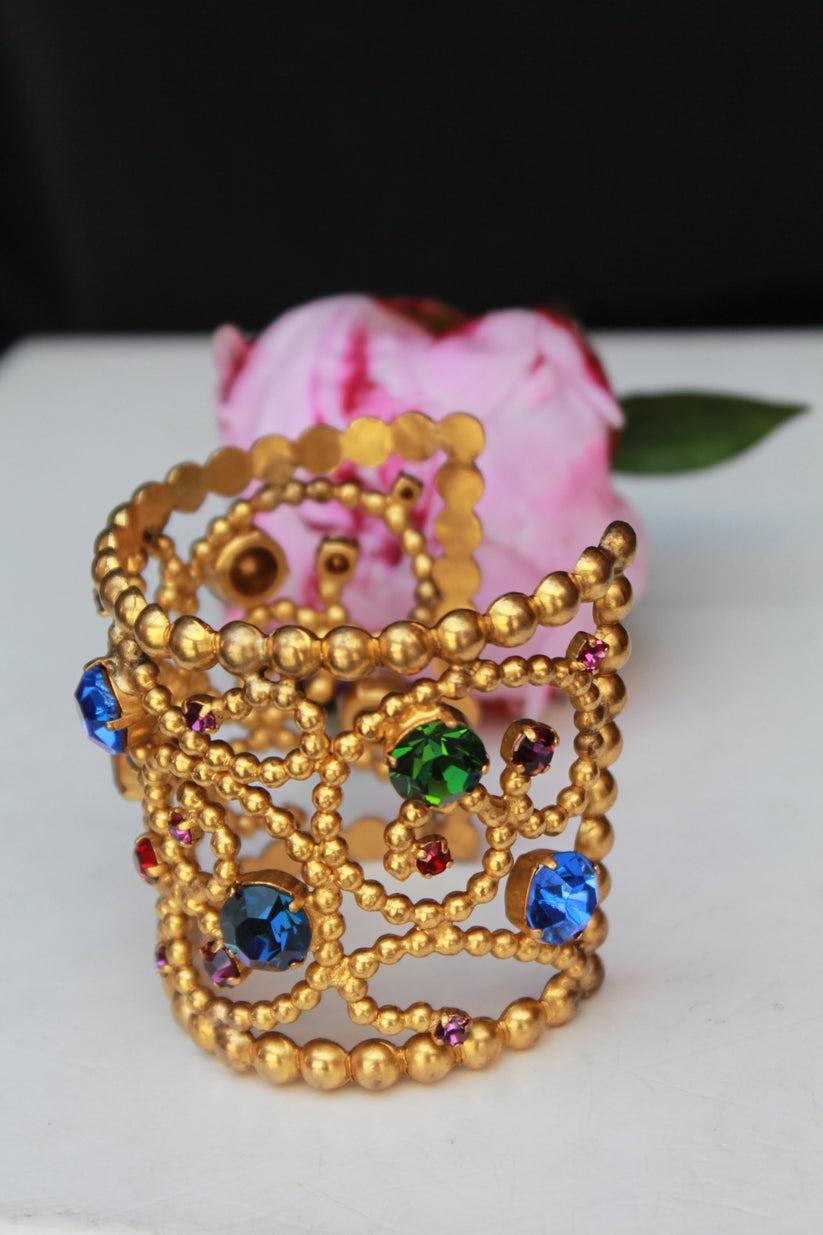 Yves Saint Laurent - Gilded metal cuff bracelet decorated with multi-color rhinestones. 

Additional information:
Condition: Very good condition
Dimensions: Height: 6 cm (2.36 in) - circumference: 12.5 cm to 14 cm (4.92
