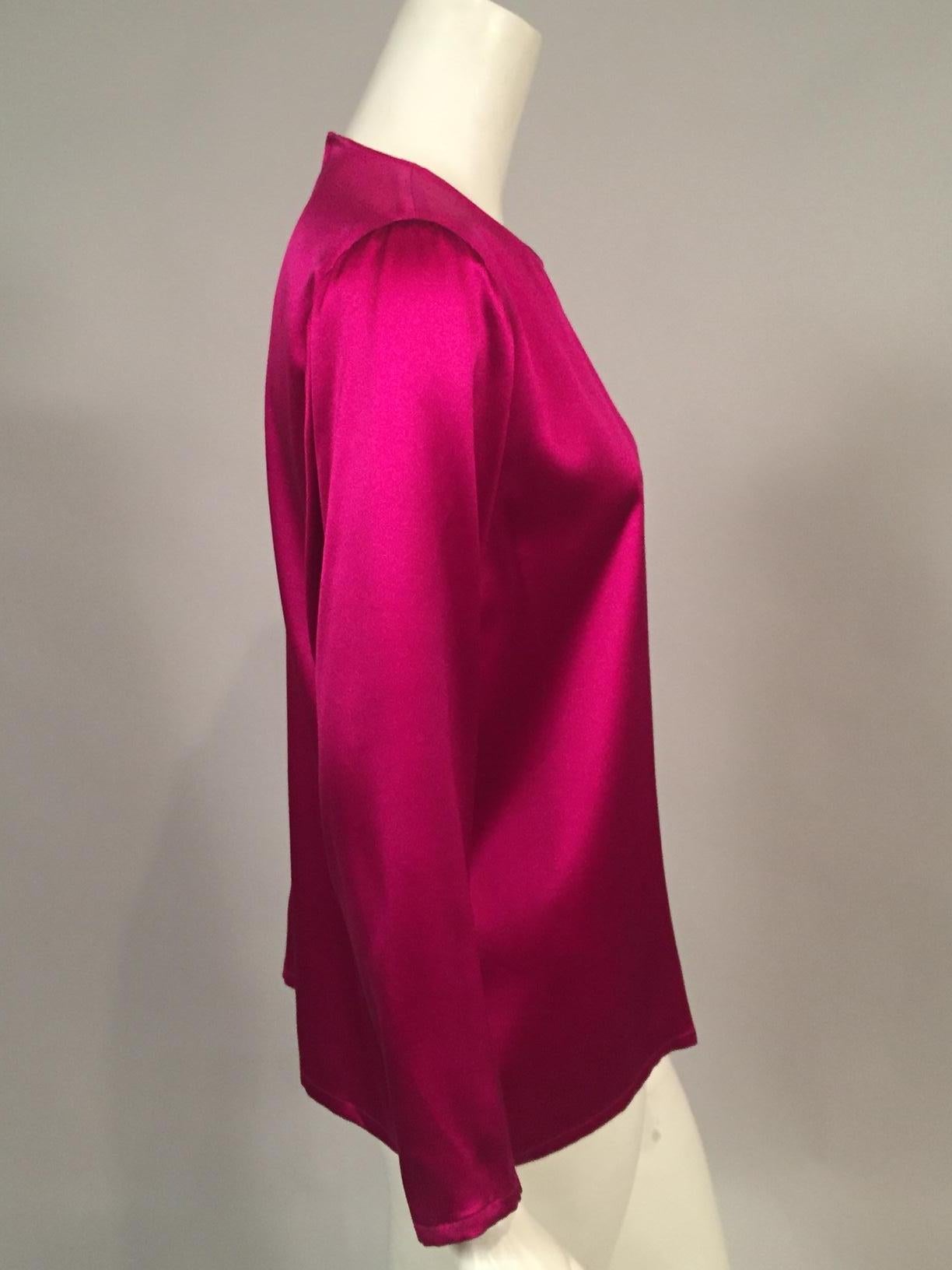 Gorgeous fabric in a gorgeous color makes this YSL blouse a go to piece in your wardrobe. It slips on over your head with a button and loop at the center back. Dress it up or dress it down, it is in excellent condition and marked a vintage size 34.