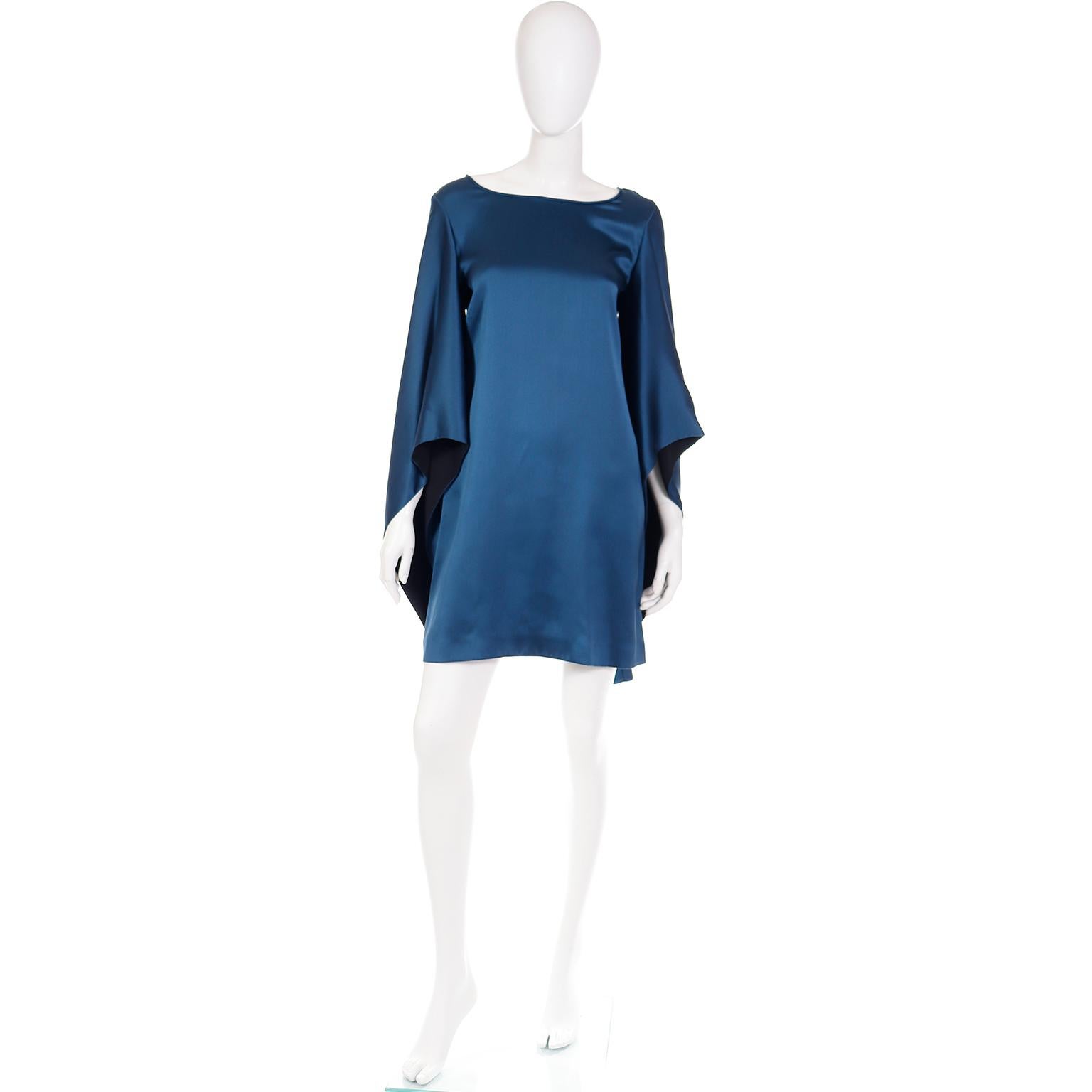 This is a really pretty vintage Yves Saint Laurent Stefano Pilati 2000's dark lapis blue shift dress with long exaggerated pagoda style sleeves. The sleeves have a black lining that shows just enough for a great contrast. The dress has a wide scoop