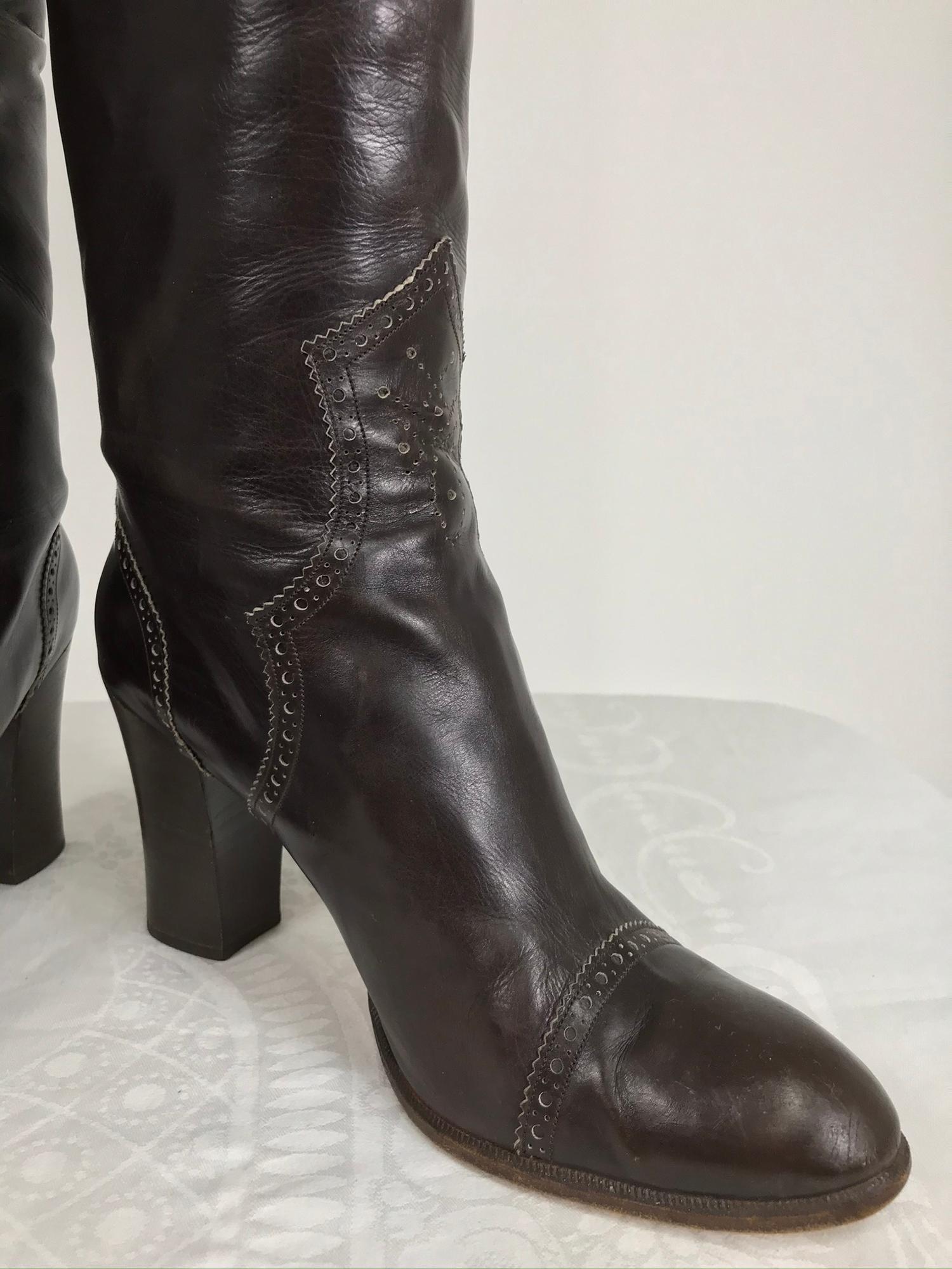 Yves Saint Laurent dark brown leather high heel boots, vintage from the 1970s in very good pre-worn condition. Round toe boots have stacked leather heels. The decorative perforations at the top band, back seam, toe band and ankle fronts are accented