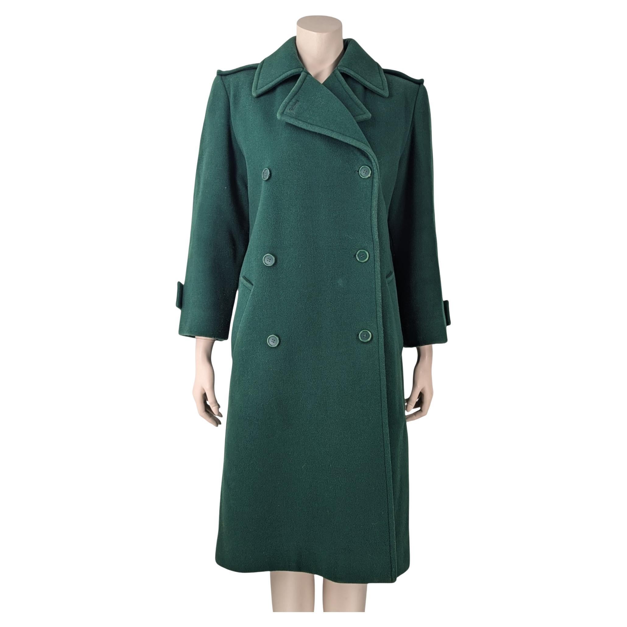 Yves Saint Laurent coat hand made by the bolduc under the brand name (reference indecipherable).

Long coat in tick woollen sheet with long sleeves with tab details on shoulders and bottom sleeves, hand-laid satin lining, double-breasted, tailored