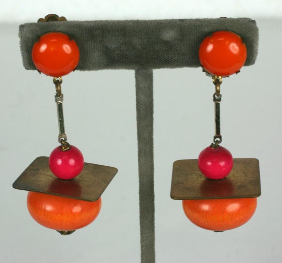 Yves Saint Laurent 1966 laquered wood and polished brass Rive Gauche drop ear clips.  Of signature YSL orange and fuschia colors. The modern design with ethnic references.
Excellent Condition. Early YSL Unsigned.
Length 2.75