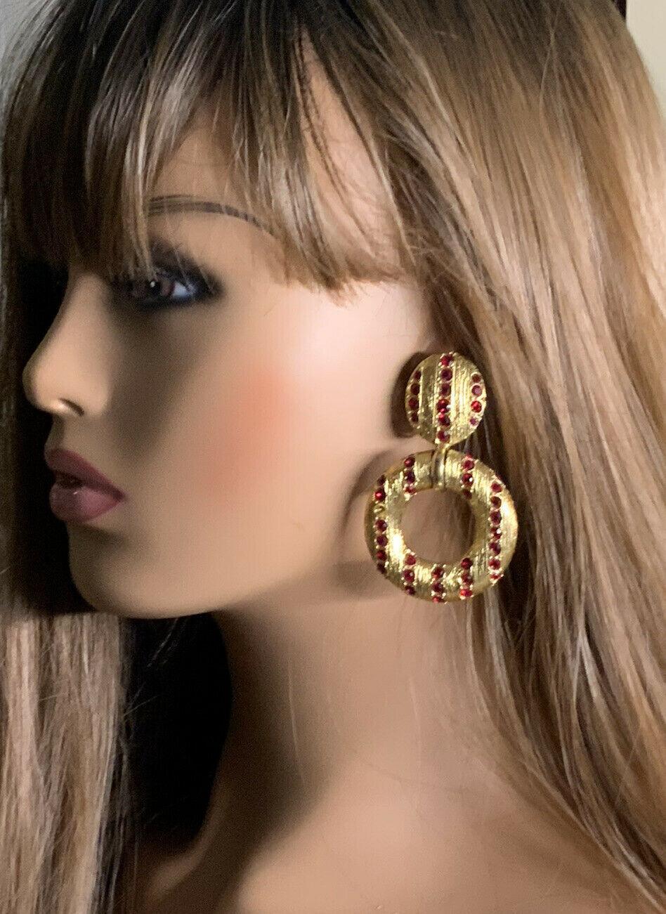 YVES SAINT LAURENT VINTAGE earrings in brass and red crystals with clips circa YSL 1980.
