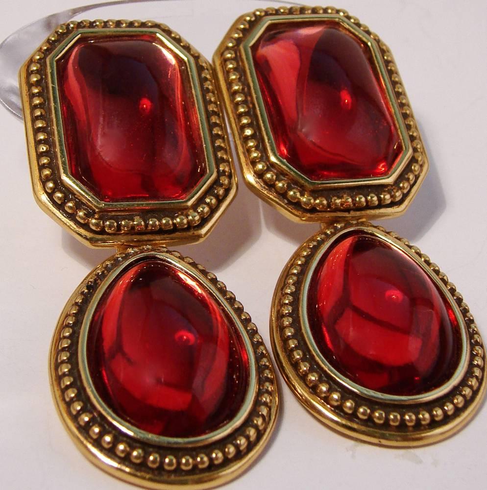 Lovely red drop earrings from Yves Saint Laurent circa late 70s are made from gold metal base and feature cherry red glass cabochons.  These earrings are clip style and carry the YSL stamp on back of each.  In excellent condition for their 40+ years