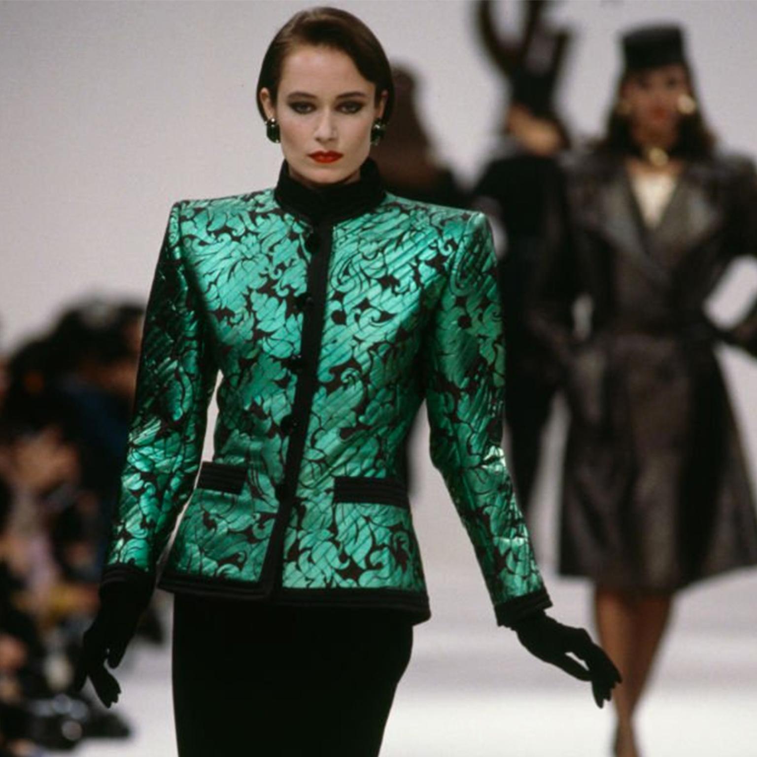 This is a stunning vintage Yves Saint Laurent Fall/Winter 1986.87 runway documented baroque style green lame jacket with black satin quilted trim. We especially love the intricate black topstitching throughout the jacket that makes it so