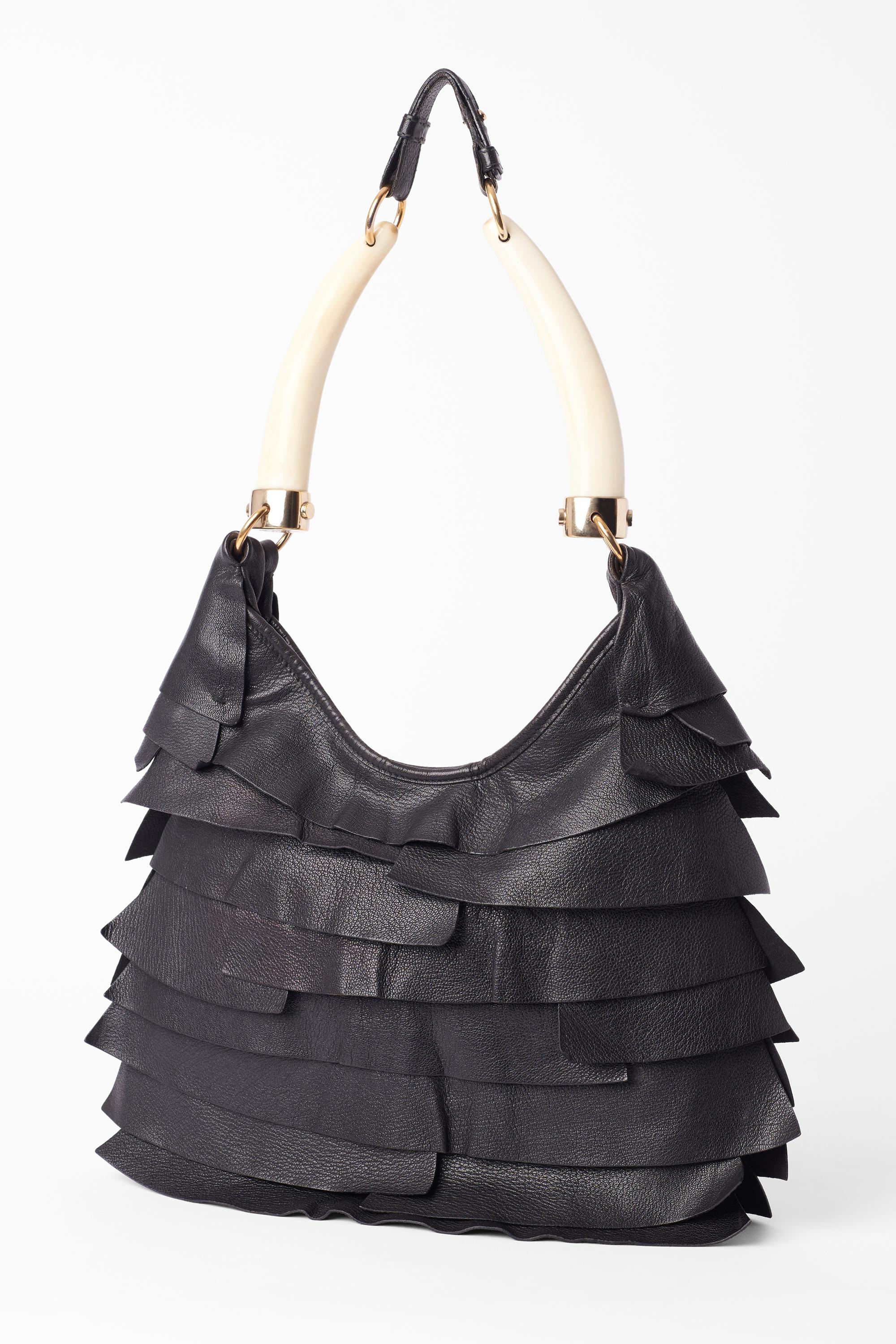 YSL by Tom Ford black St Tropez ruffled bag from the Fall/Winter 2004 Rive Gauche. Features double Horn handle , adjustable strap, ruffled leather body magnetic button closure. YSL branded in shiny gold tone, inner zip pocket. In excellent vintage