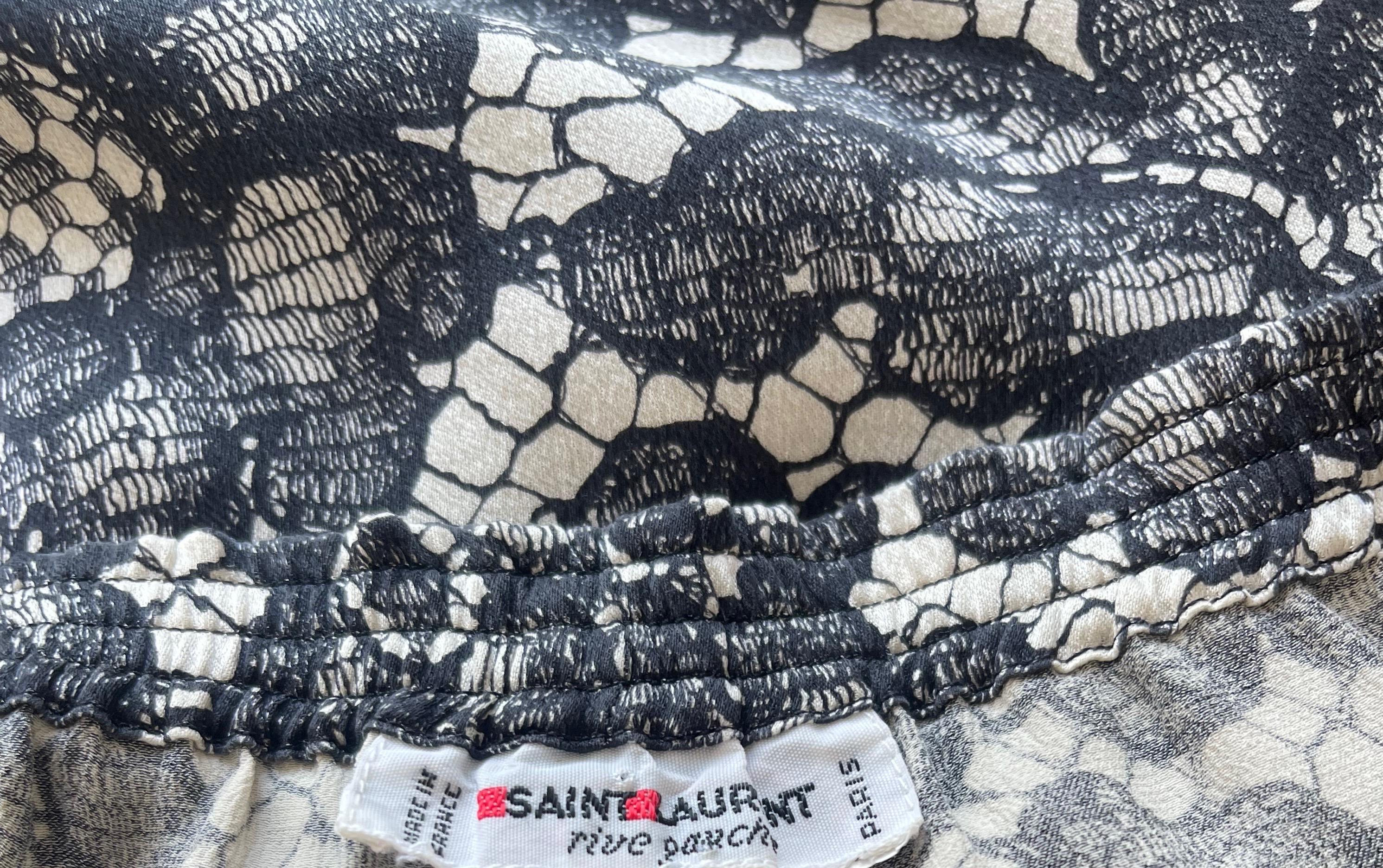Rare vintage YSL Fall 1984 black and white trompe l’oeil black and white lace print silk trousers ! Features an all over black and white lace print. Pockets at each side of the hips. Elastic waistband can accommodate an array of sizes. 
Pair with a