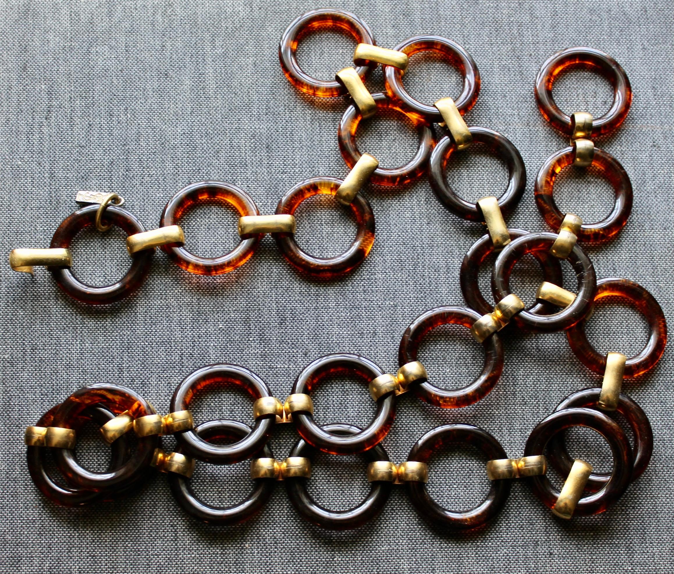 Offering a Yves Saint Laurent vintage brass links connecting lucite rings, size adjustable.
YSL engraved metal logo tag.  France 1970's.  Total length
37