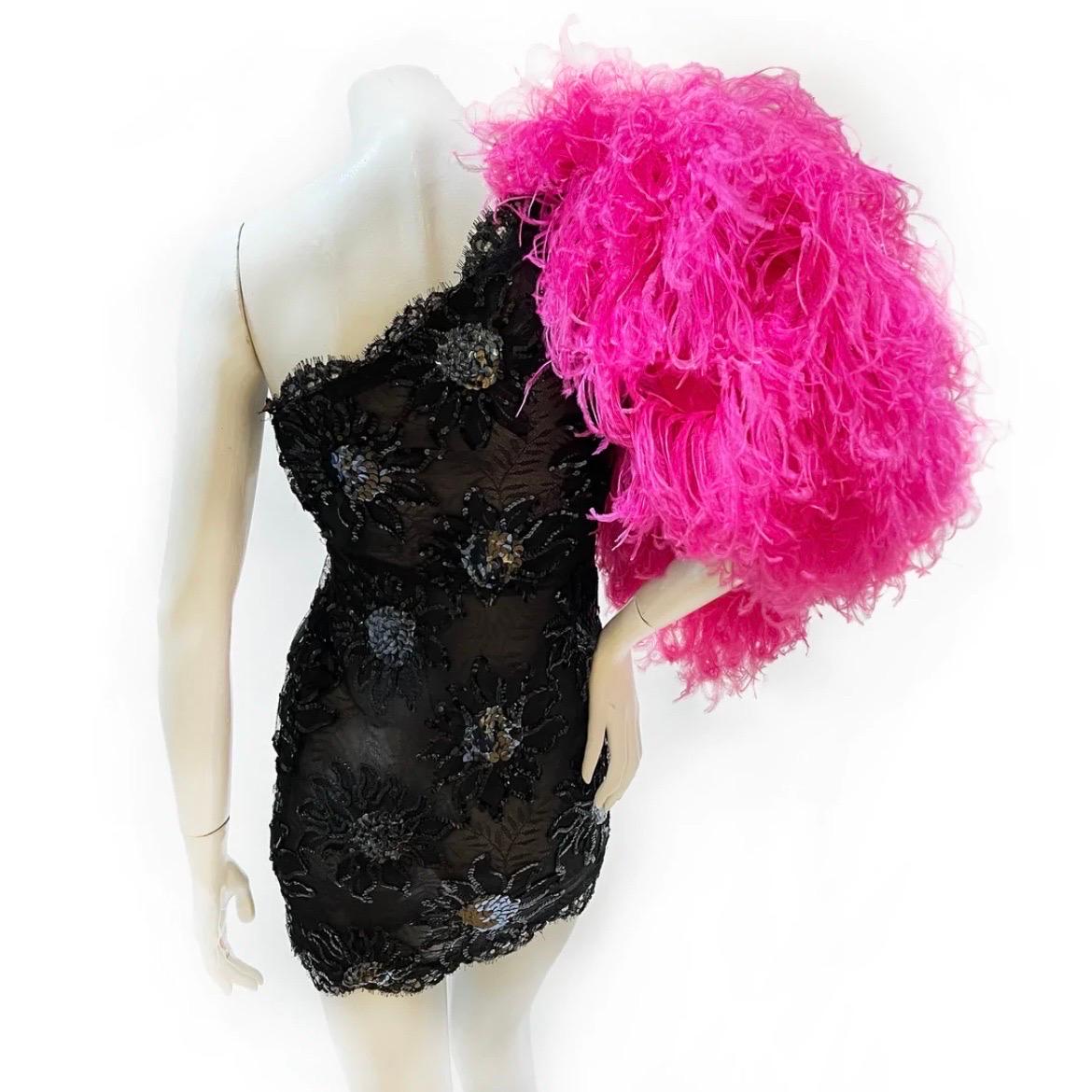 Sequin Feather One Sleeve Dress by Yves Saint Laurent 
Spring/Summer RTW 1991
Single puff sleeve consisting of hot pink feathers
Black semi-sheer lace 
Black/silver embroidered sequin floral patter throughout 
Side zip closure
Mini dress, body