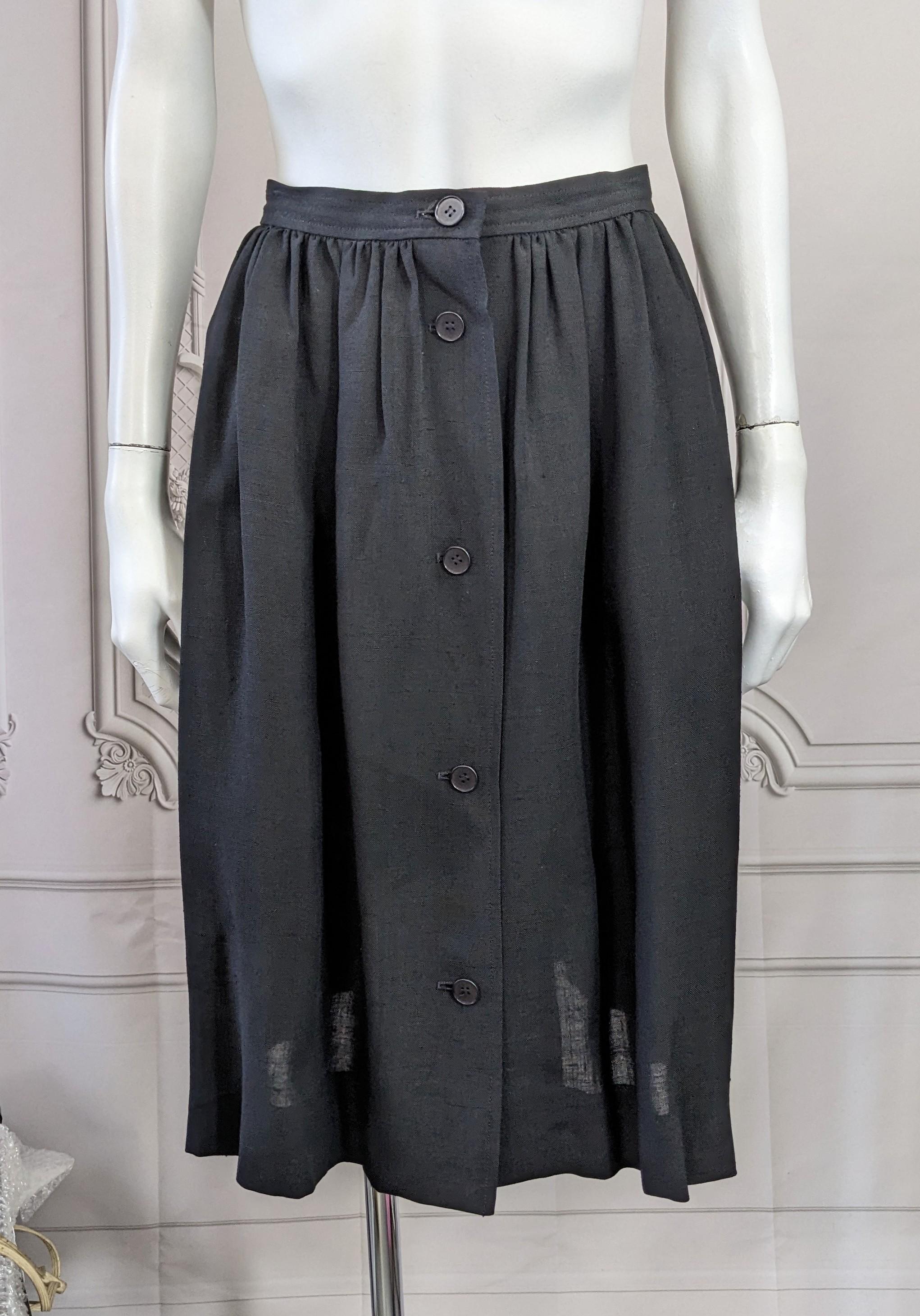 Yves Saint Laurent Fibranne Skirt, Rive Gauche in black rayon linen blend from the 1980's. Full gathers in front with less on back with button front entry. Classic timeless, 1980's France. Vintage size 42.
