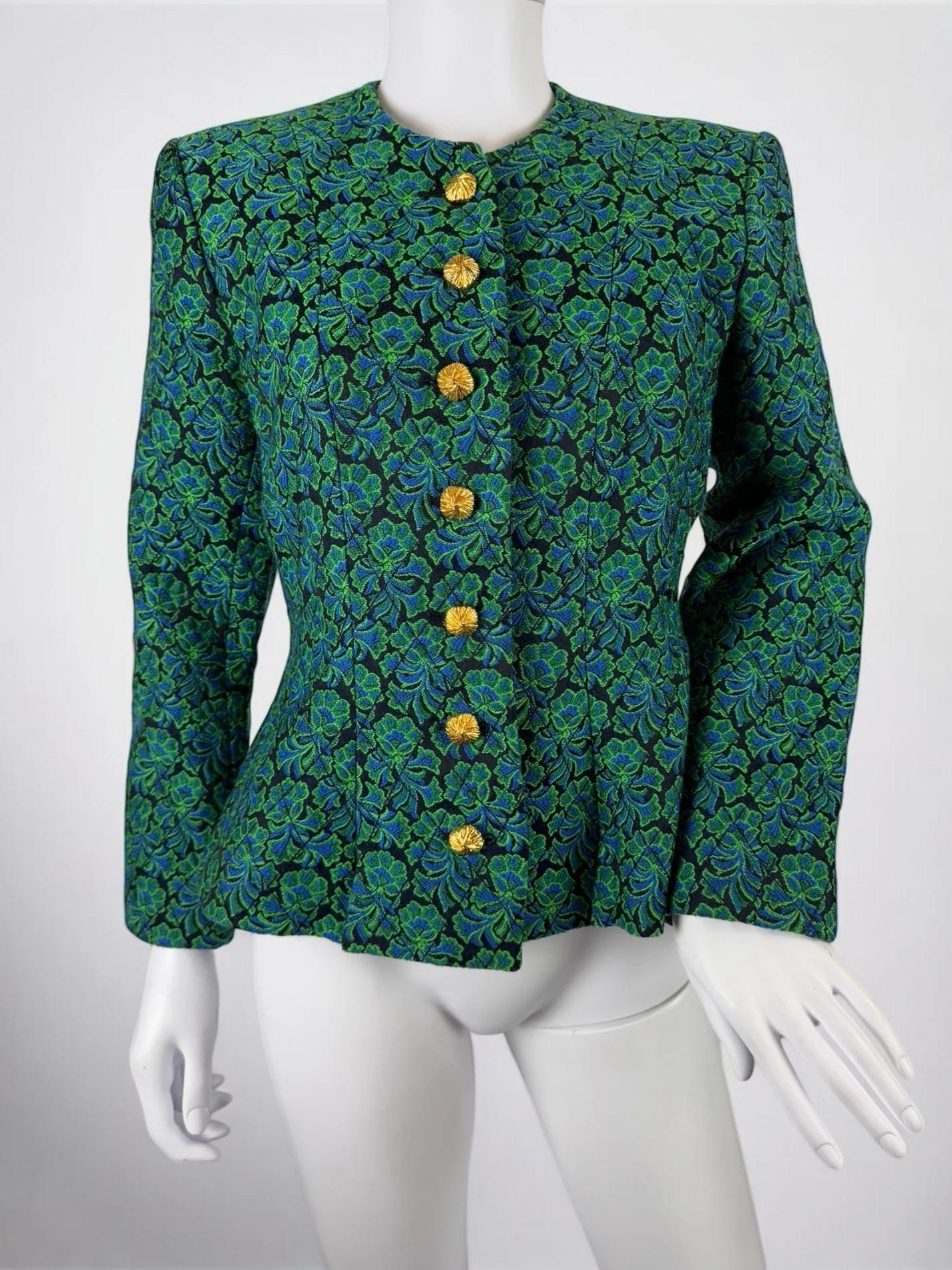 Yves Saint Laurent Rive Gauche jacquard floral jacket, lare 1980s
Beautiful gold toned buttons
Black base with bright green and blue florals
Wonderful shape with a slightly defined waist and subtle shoulder pads
72% wool 28% acetate
Very good