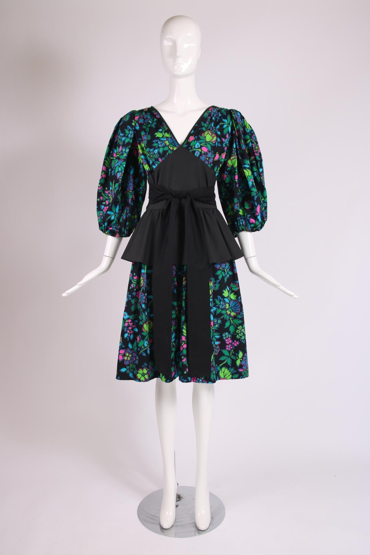 Yves Saint Laurent floral print cotton dress with black yoke at bodice, black peplum, balloon sleeves and black self belt. No size tag - please consult measurements.

Bust - 36