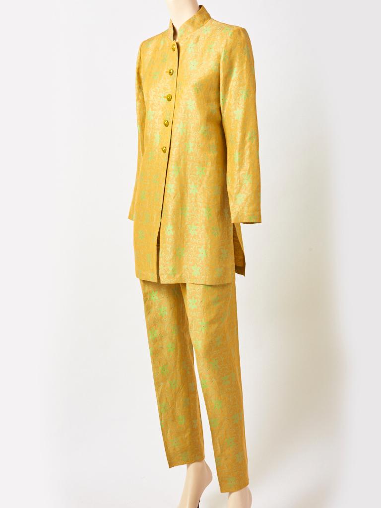 Yves Saint Laurent, Rive Gauche, silk damask, tunic and pant ensemble in a yellow gold, with a Celedon green floral pattern. Tunic top is Indian inspired, having a Nehru collar with a semi fitted silhouette and side slits. Button closures are made