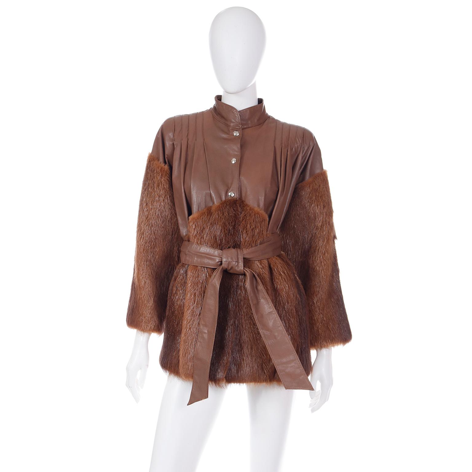 This is a luxe vintage Yves Saint Laurent Fourrures jacket in brown leather with fur trim. The fully lined jacket has its original leather belt and snaps up the front for closure. The fur is on the sleeves from just below the shoulders and it