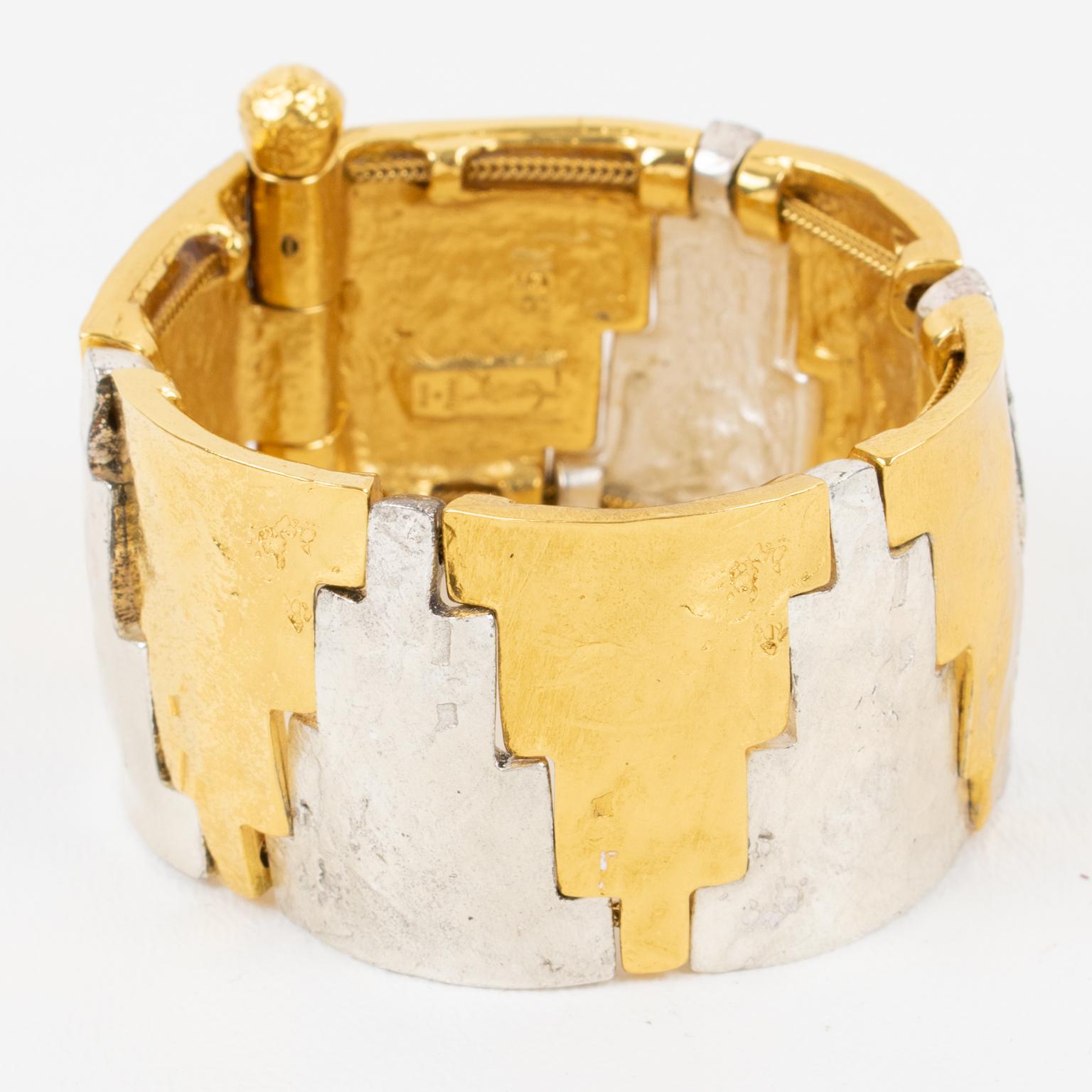 Refined Yves Saint Laurent Paris link bracelet bangle designed by Robert Goossens. The rare piece features geometric elements in gilt metal and silver plate metal, all textured with a handmade feel. The bracelet is built with a double serpentine