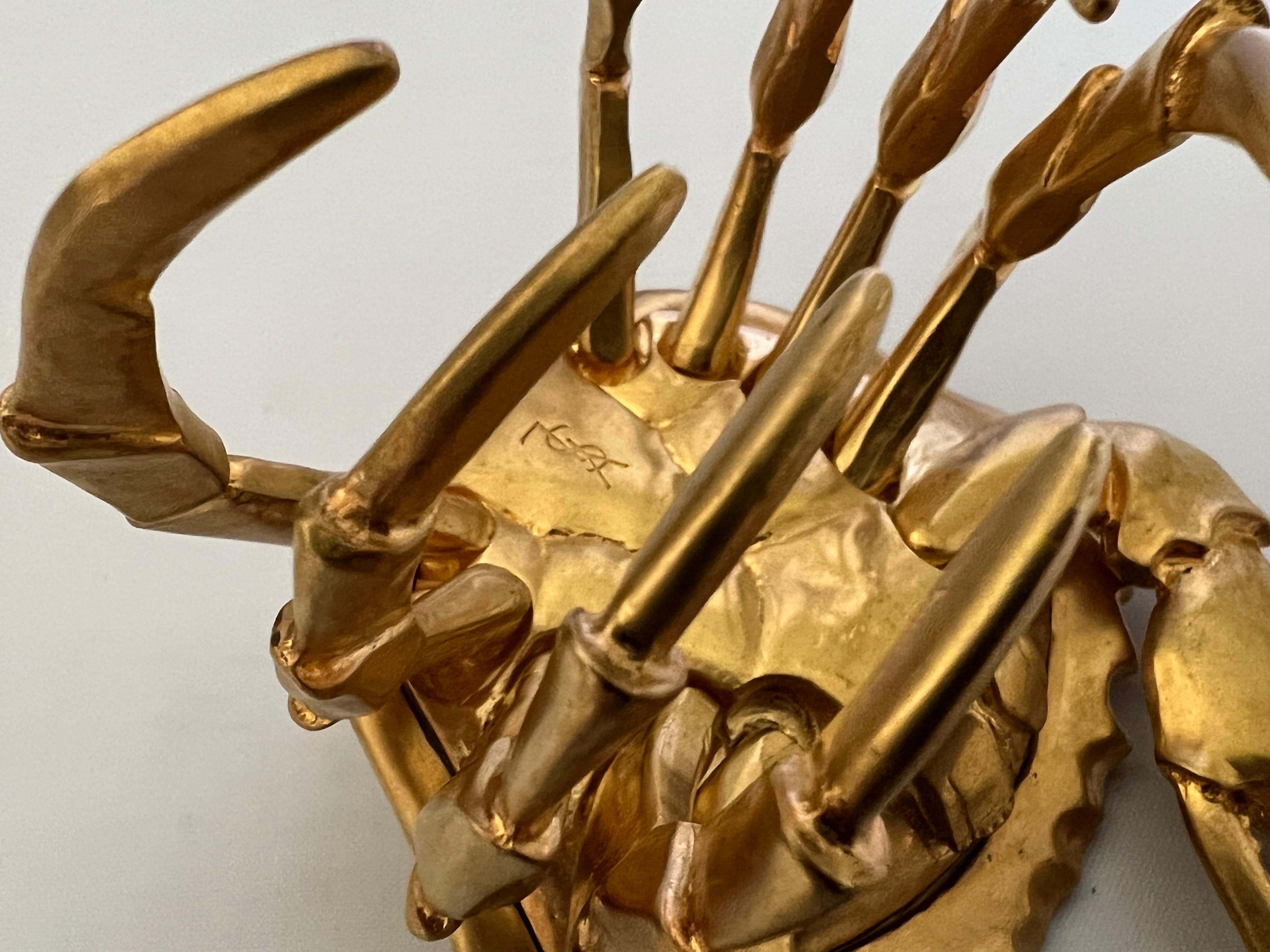 Scarce Yves Saint Laurent gilt metal articulated crab cuff bracelet. Signed Yves Saint Laurent, made in France.