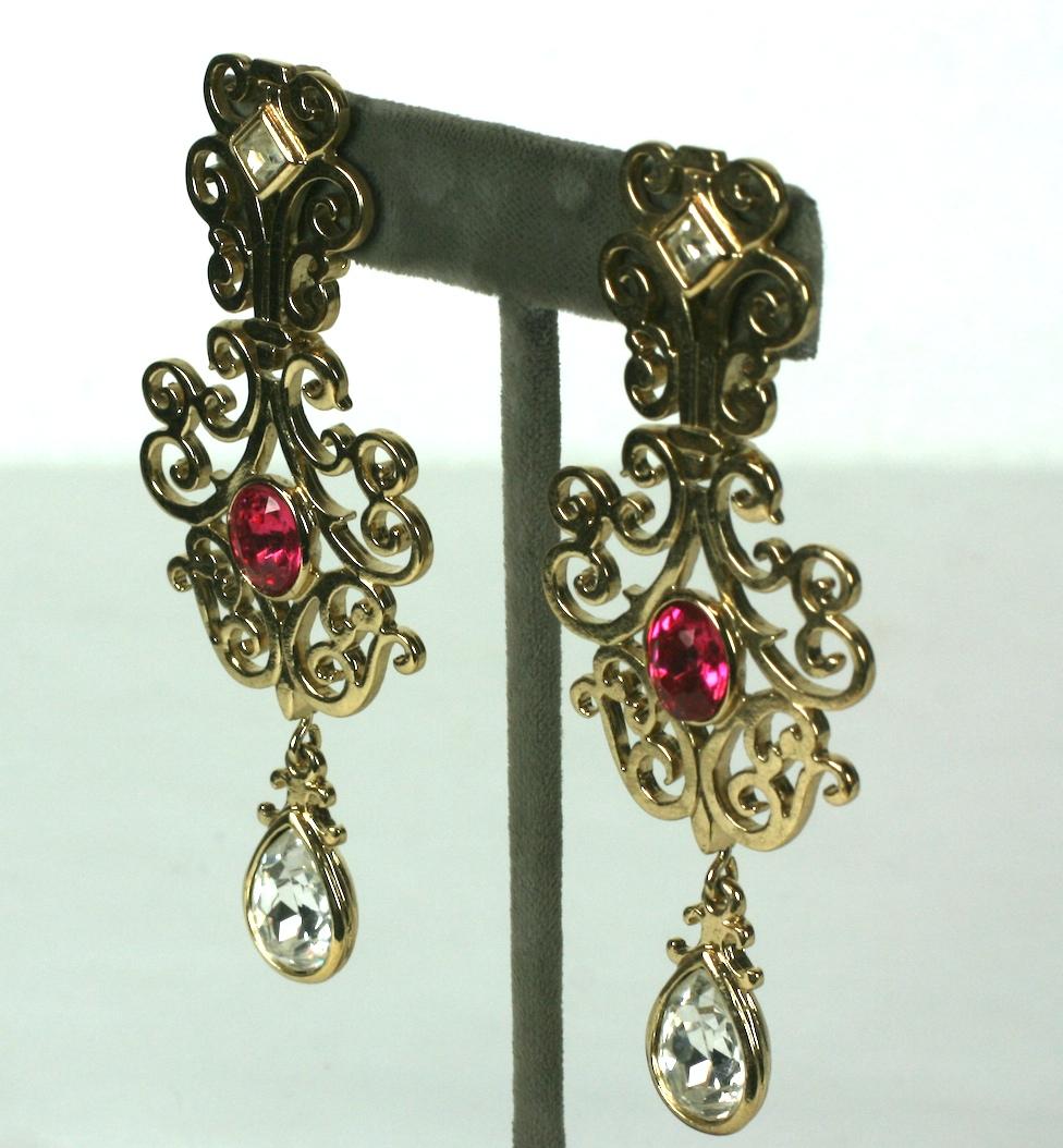 Dramatic Yves Saint Laurent Gilt Fretwork Earrings with clip back fittings accented with pink and crystal accents. Long striking size.  1990's France.
3.5