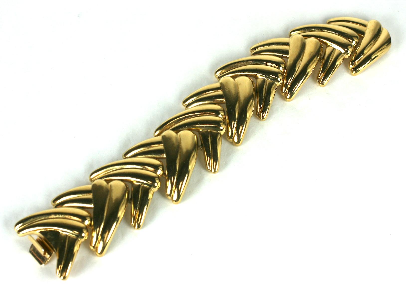 Striking Yves Saint Laurent Gilt Leaf Bracelet from the 1990's France. Criss crossing leaf motifs create a braided effect when worn. 
1990's France.  8