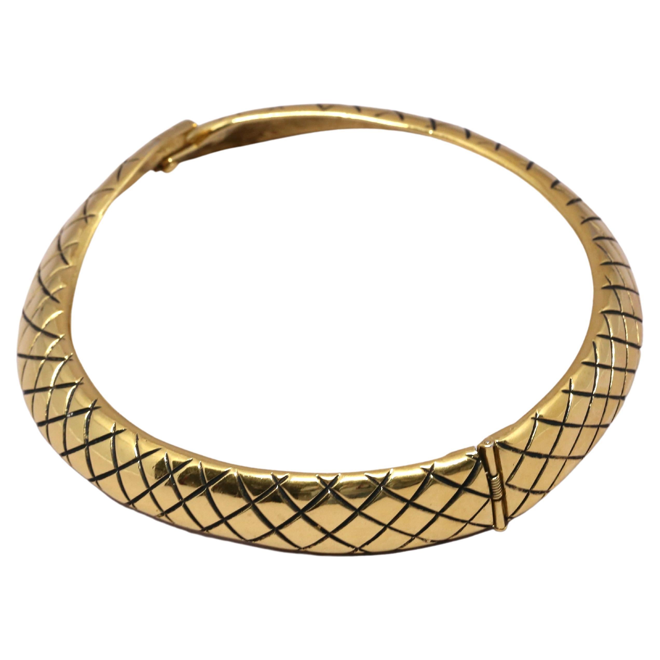 Very unique, gilt-metal necklace in the form of a stylized snake from Yves Saint Laurent dating to the 1980's. Fits a smaller sized neck. Measures approximately 13-13.5