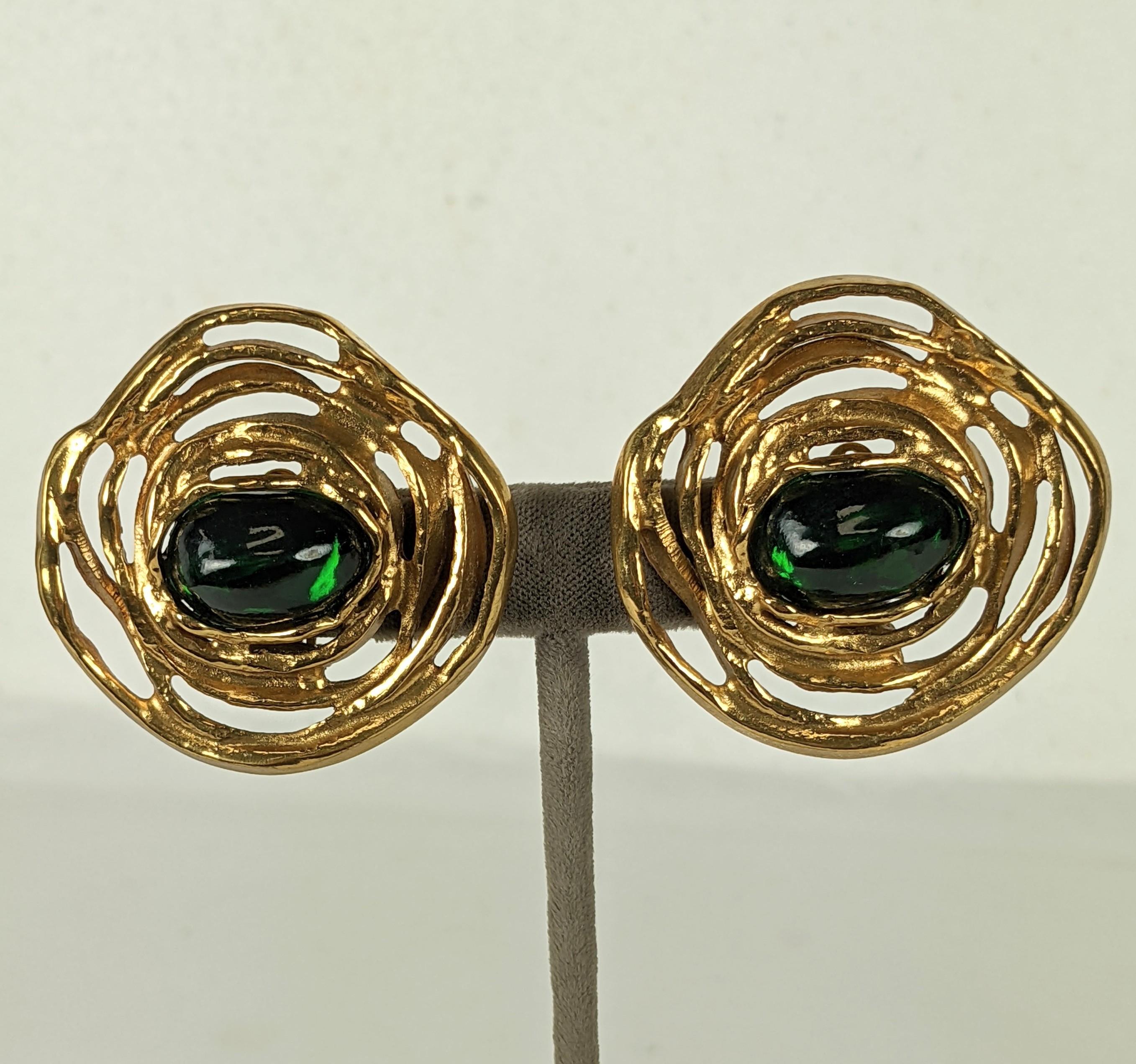 Large Yves Saint Laurent Gilt Spiral Earrings set with a single emerald pate de verre cabochon. Abstract golden ribbons float free form around central cab. Made by Maison Goossens. Clip back fittings.  France Late 1980's.   1.75