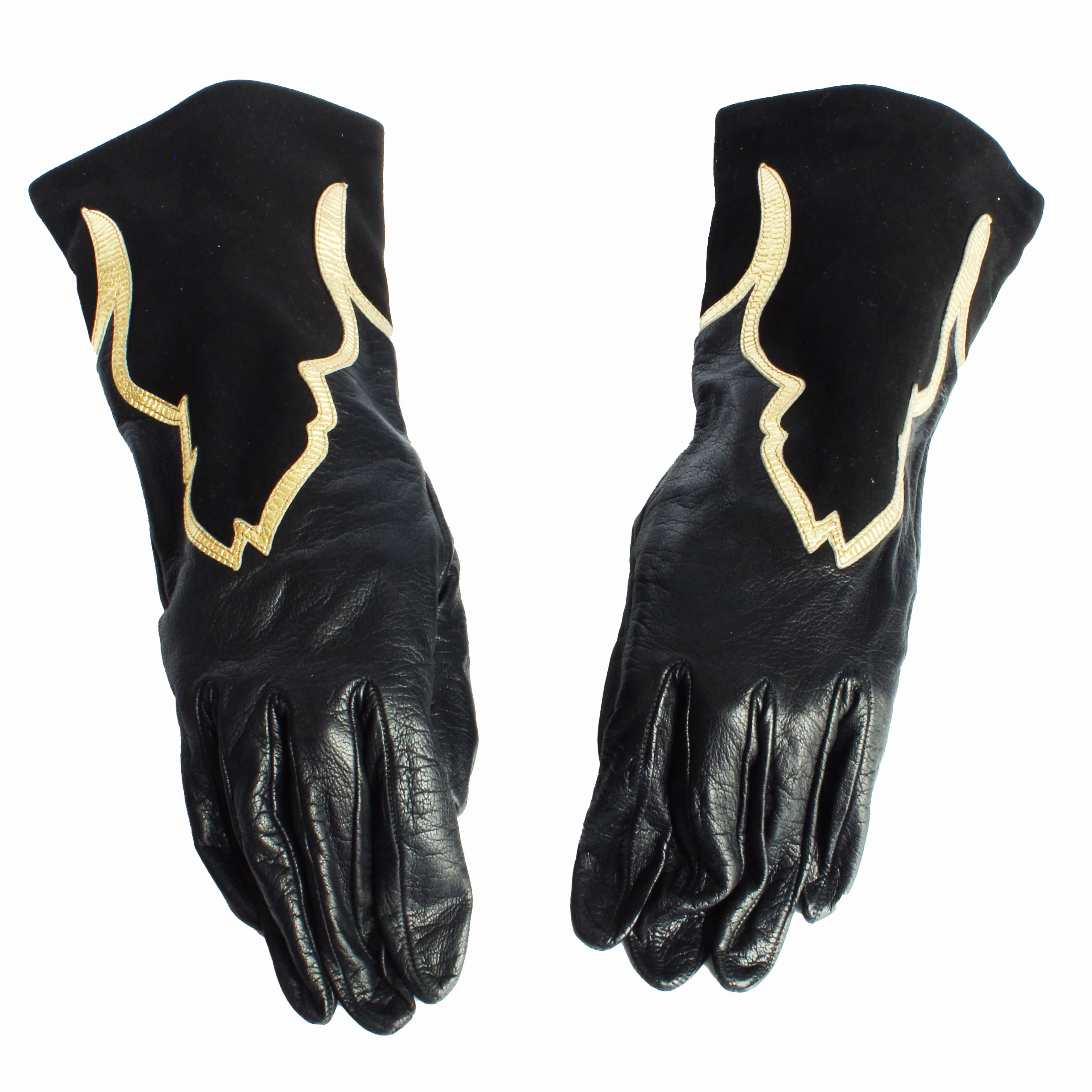 Preowned, vintage gloves by Yves Saint Laurent, likely made in the 90s.  Made from supple black leather, they features black suede Moroccan inspired inserts on the top that are trimmed in shimmery gold leather.

A fabulous pair of gloves that will