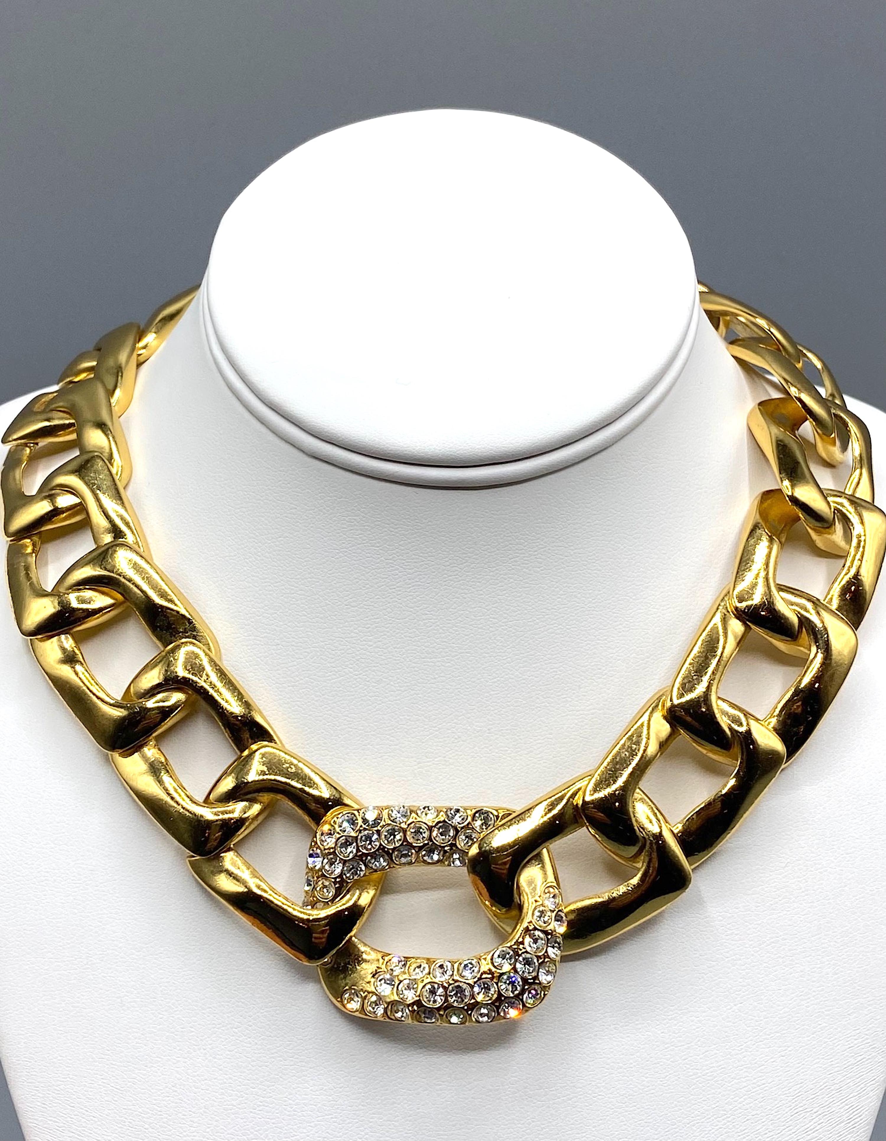Classic 1980s design is this gold plate  Yves Saint Laurent necklace large link necklace.
The central and largest link is 1.5 inches high and set with rhinestones. From the center rhinestone link, each chain gradually get smaller toward the back of
