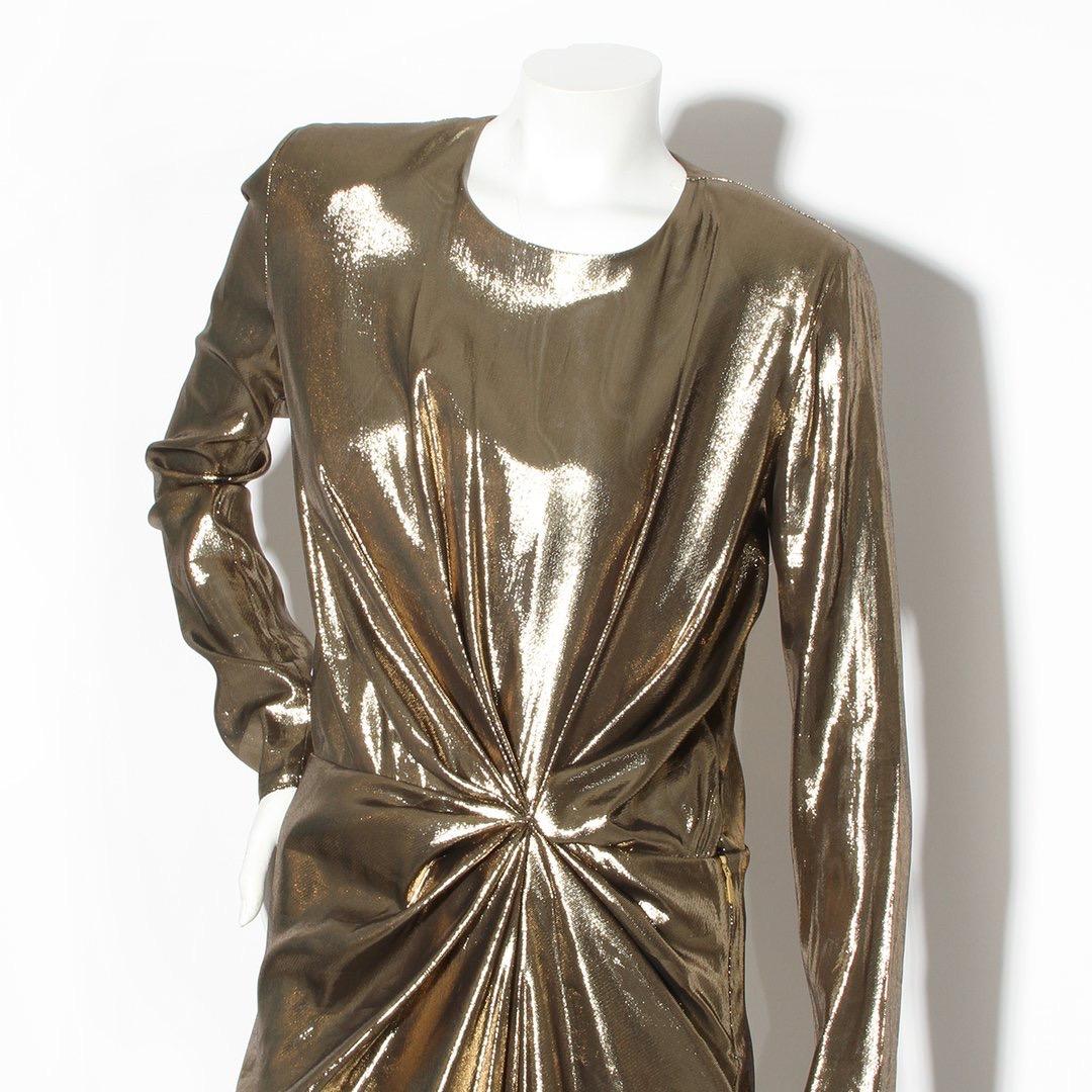 Gold metallic dress by Yves Saint Laurent
2017 Spring RTW Collection 
Long sleeve 
Gold lame 
Slight shoulder pad 
Keyhole back with button closure 
Front wrap slit
Asymmetrical hem 
Zip and snap side closure 
Made in France
Condition: Excellent,