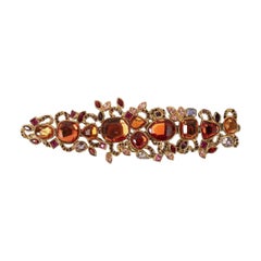 Bracciale in metallo dorato e strass di Yves Saint Laurent