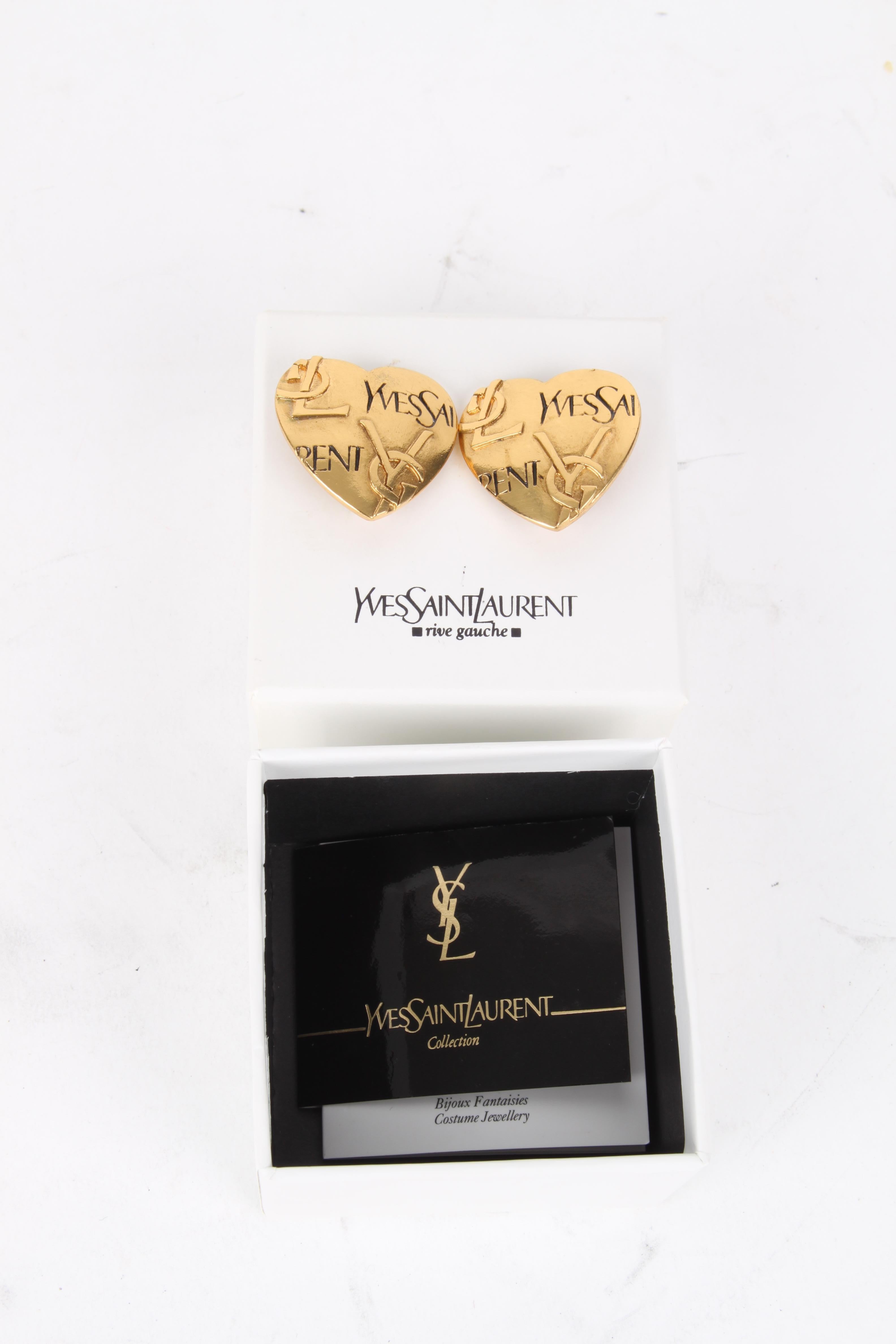 Yves Saint Laurent Gold-Plated Logo Heart Clip-On Earrings.

These earrings feature a lux gold-plated logo exterior with a matching glossy finish. The earrings feature a gold-plated backside clip fastening that carries the authenticity stamp. The