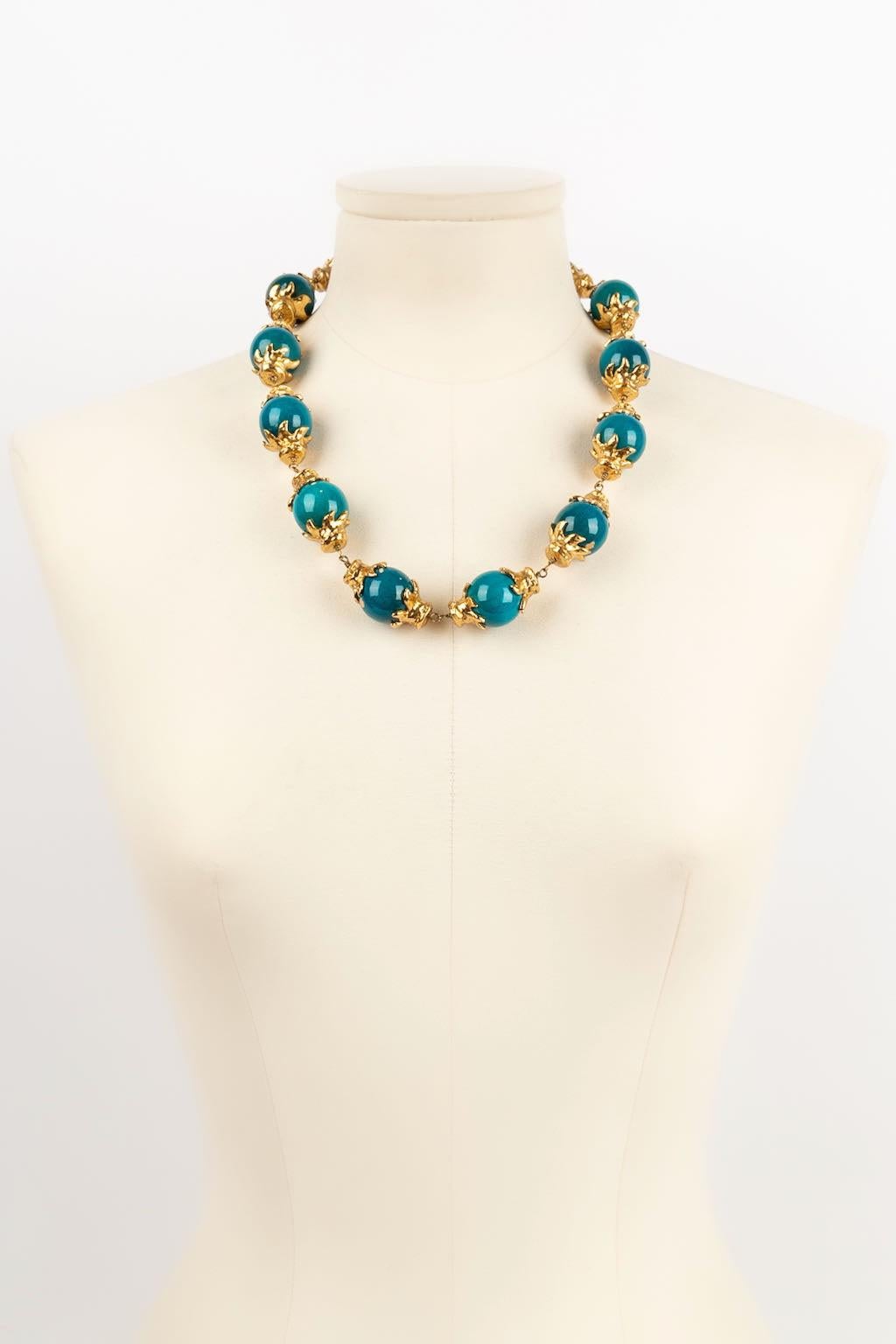Yves Saint Laurent - (Made in France) Gold plated metal necklace with blue wooden beads.

Additional information: 
Dimensions: Length: from 53 cm to 58 cm
Condition: Good condition
Seller Ref number: BC63