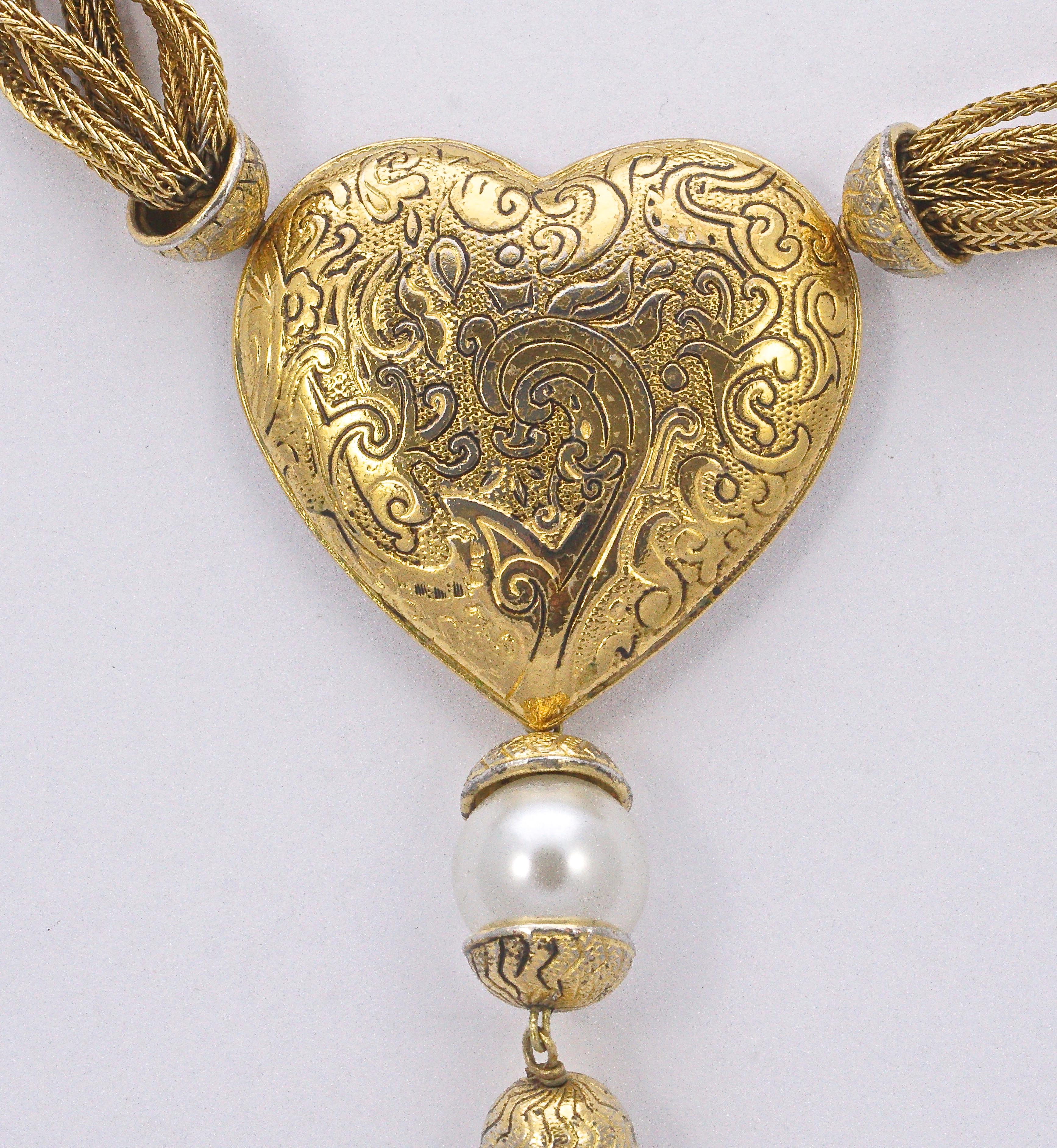Beautiful Yves Saint Laurent gold plated multi strand and pearl necklace, featuring a large swirl design heart with pearl and tassel detail, circa 1980s. The necklace is length 60cm / 23.6 inches with the adjustable toggle clasp at its maximum, and