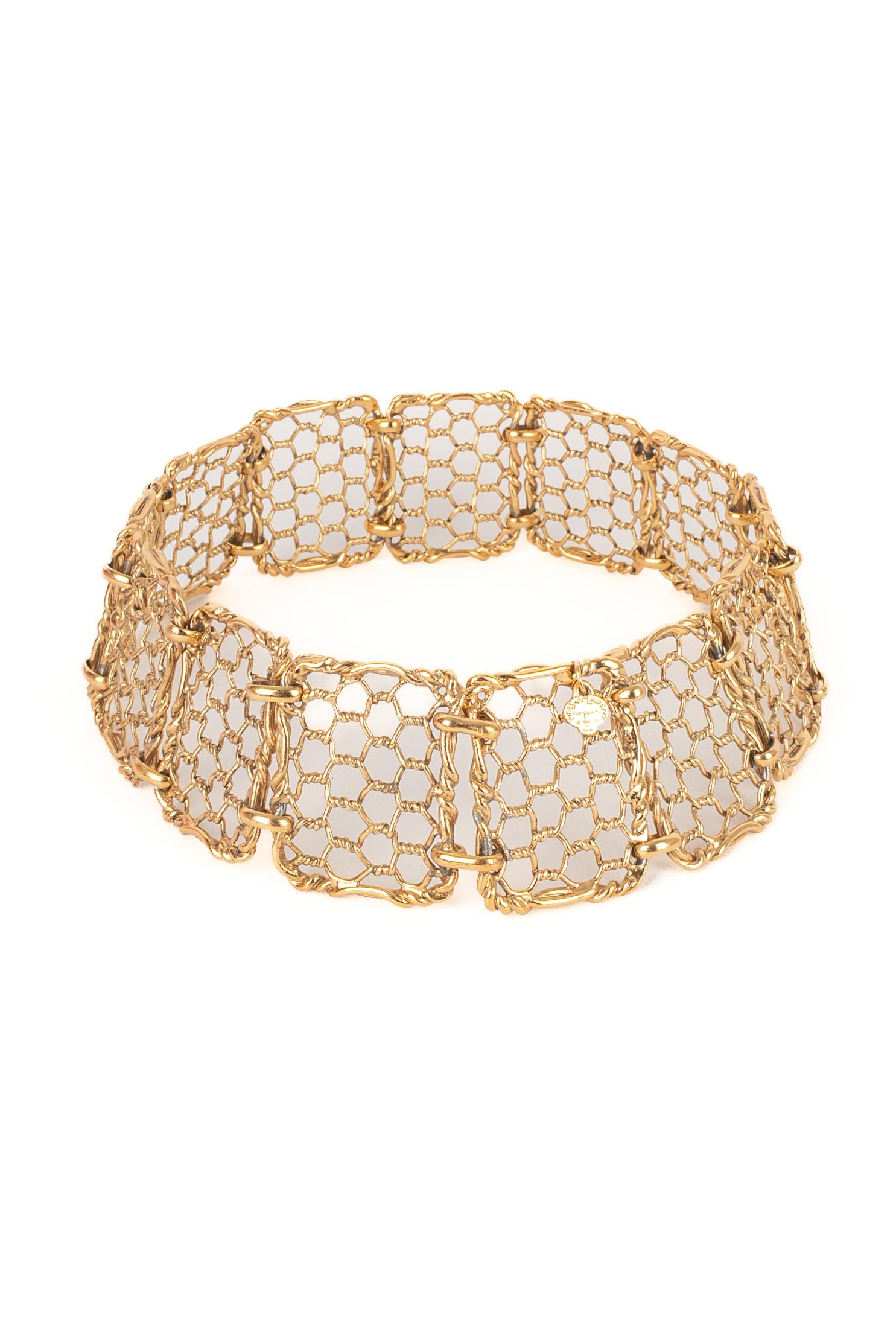 YVES SAINT LAURENT - (Made in France) Openwork golden metal articulated belt.

Condition:
Good condition

Dimensions:
Length: 66 cm - Width: 6.5 cm

SKU:ACC198