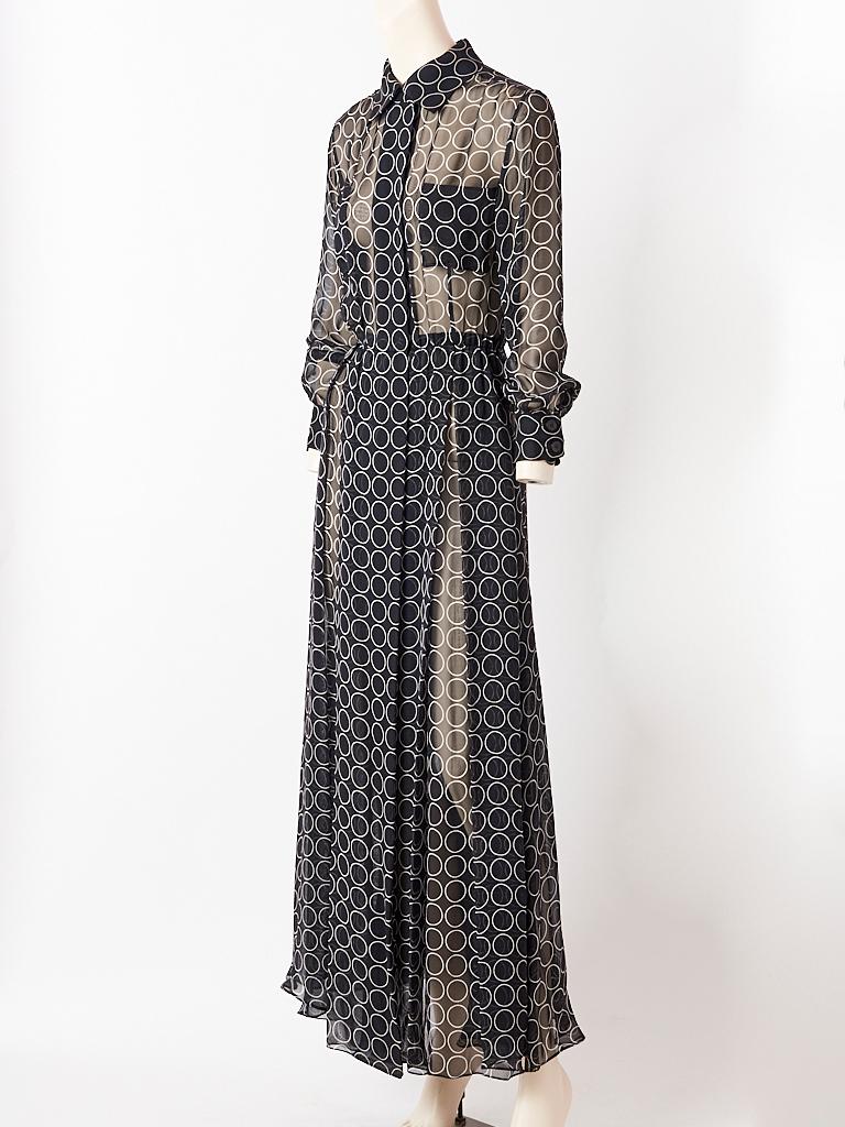 Yves Saint Laurent, black and white,  silk georgette, circle pattern, maxi, shirt dress having hidden front button closures, a small pointed collar, long cuffed sleeves and small, bust pockets. Skirt is very generous with loose box pleating.