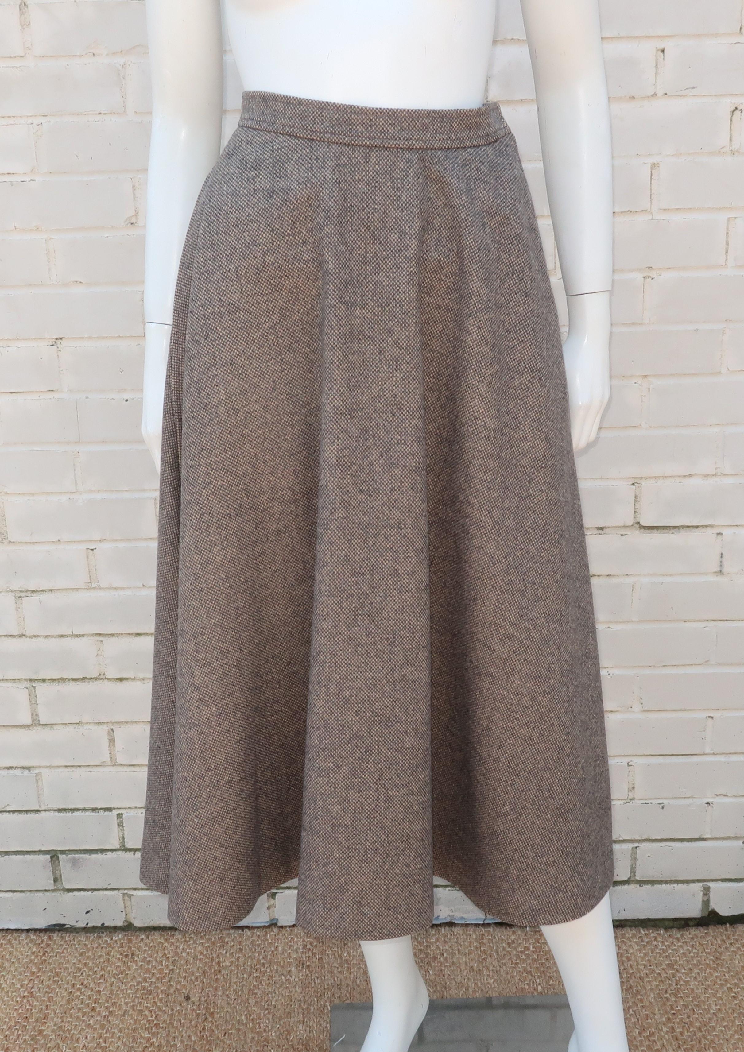 1970's Yves Saint Laurent wool tweed flared skirt in shades of gray and tan.  The skirt hooks and zips at the side with hidden pockets and no lining.  It promises to be a Fall and Winter wardrobe staple ... perfect paired with cropped jackets and