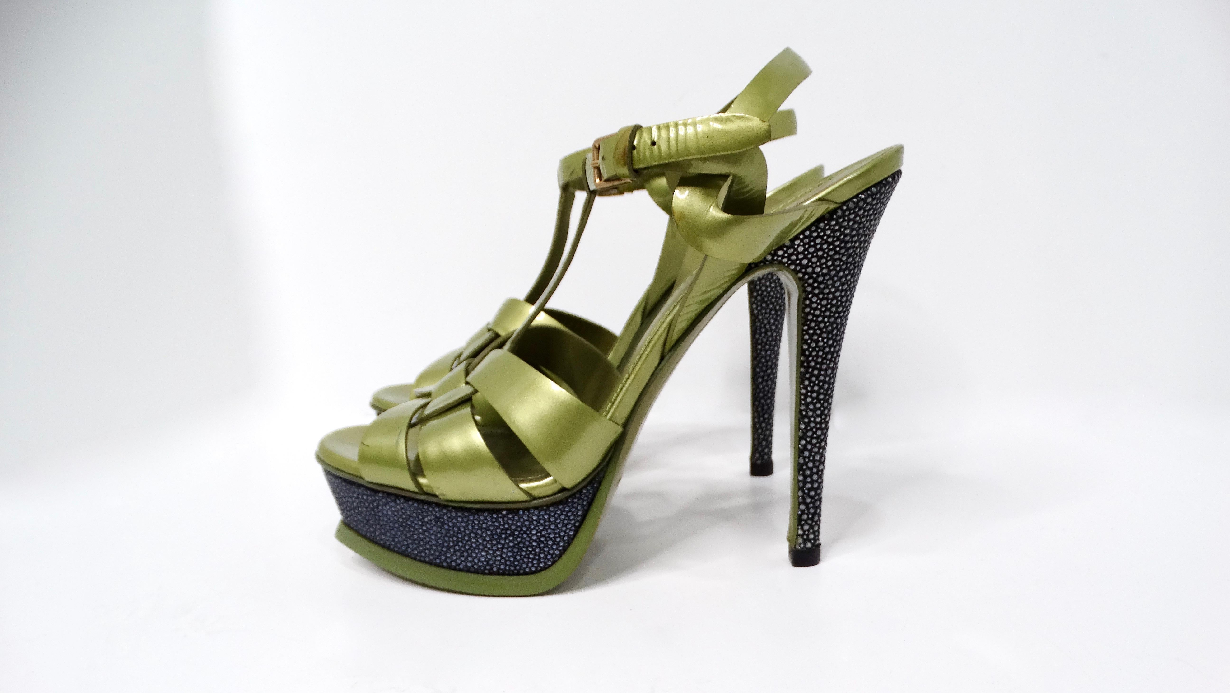 Step into the spotlight with the Yves Saint Laurent Green Tribute Patent Leather Platform High Heels, an embodiment of luxury and sophistication. These striking heels feature a captivating green patent leather upper, complemented by a black spotted