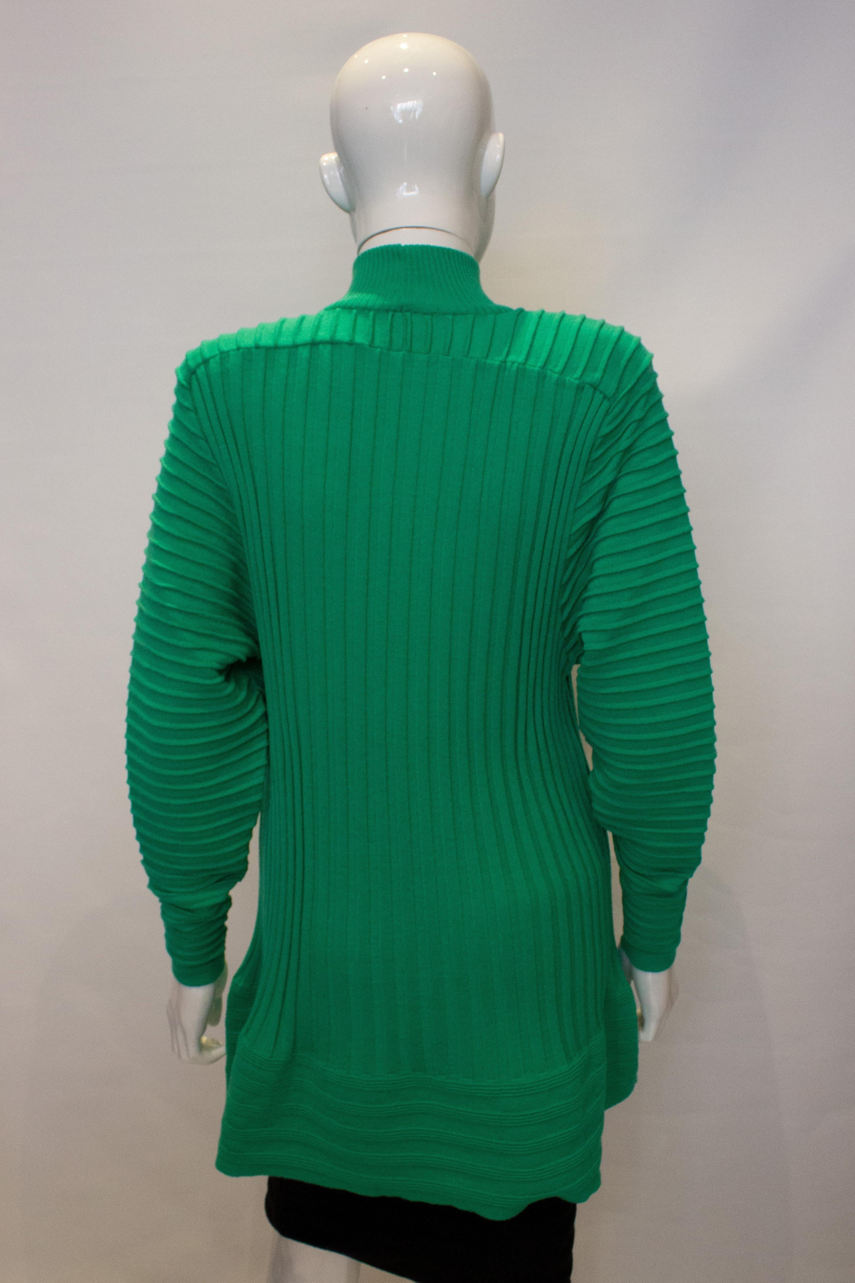 A fun tunic/mini dress for Fall, by Yves Saint Laurent , Variation. In  a green wool, the tunic /dress has ribbed detail and an attractive flared hemline. Size 38 , Bust up to 39/40'', length 30''