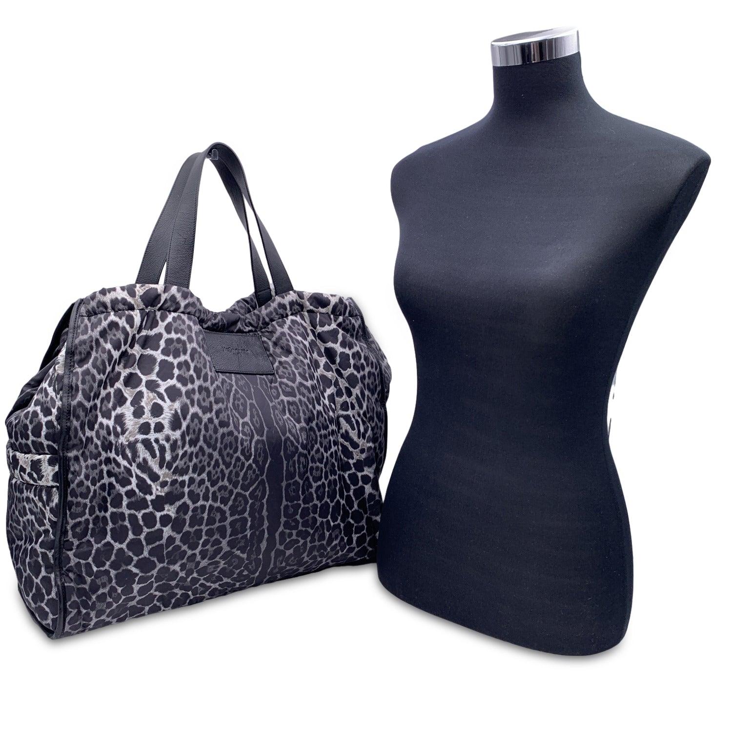 Yves Saint Laurent animalier leopard print large tote. Animalier nylon (slightly padded) with black genuin eleather trim and handles. Nylon lining. 1 side zip pocket and 2 side open pockets inside. 'YVES SAINT LAURENT' tag inside (with 'Made in