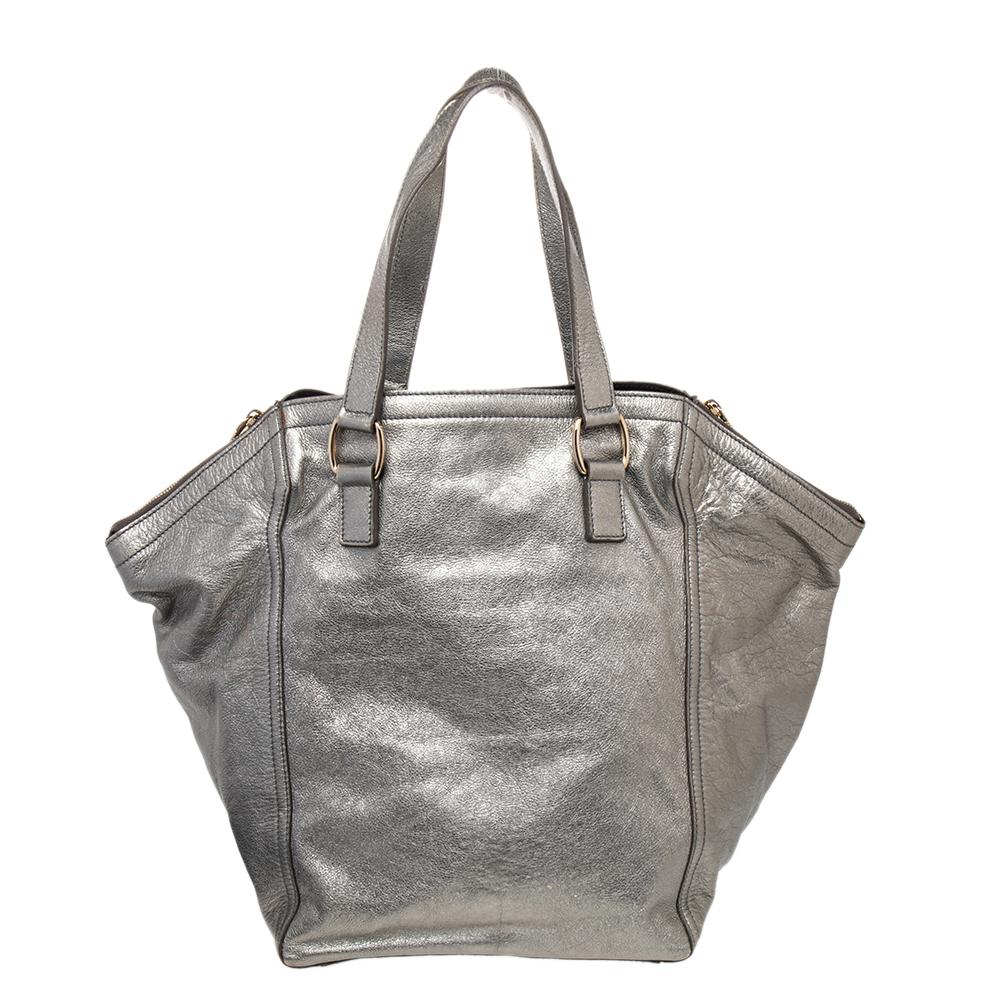 Every woman needs a bag that is pretty and functional, just like this Downtown tote from Saint Laurent. Crafted with precision using metallic leather, the bag has been styled with zippers and buckles. It also features two handles, and a top which