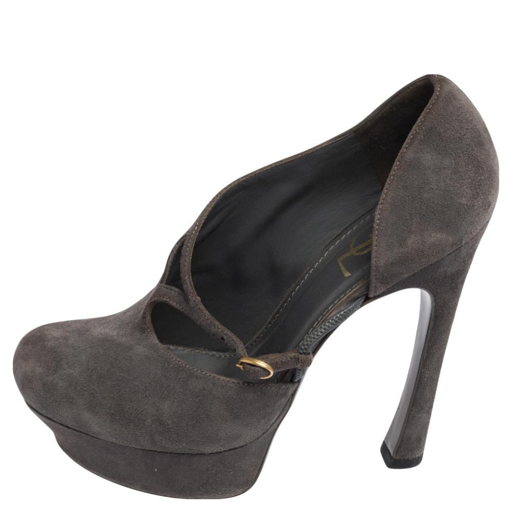A classic to add to one's shoe collection is this pair! Crafted by Yves Saint Laurent using suede in a grey shade, the pumps are detailed with side buckles, tall heels, and sturdy platforms for maximum support.