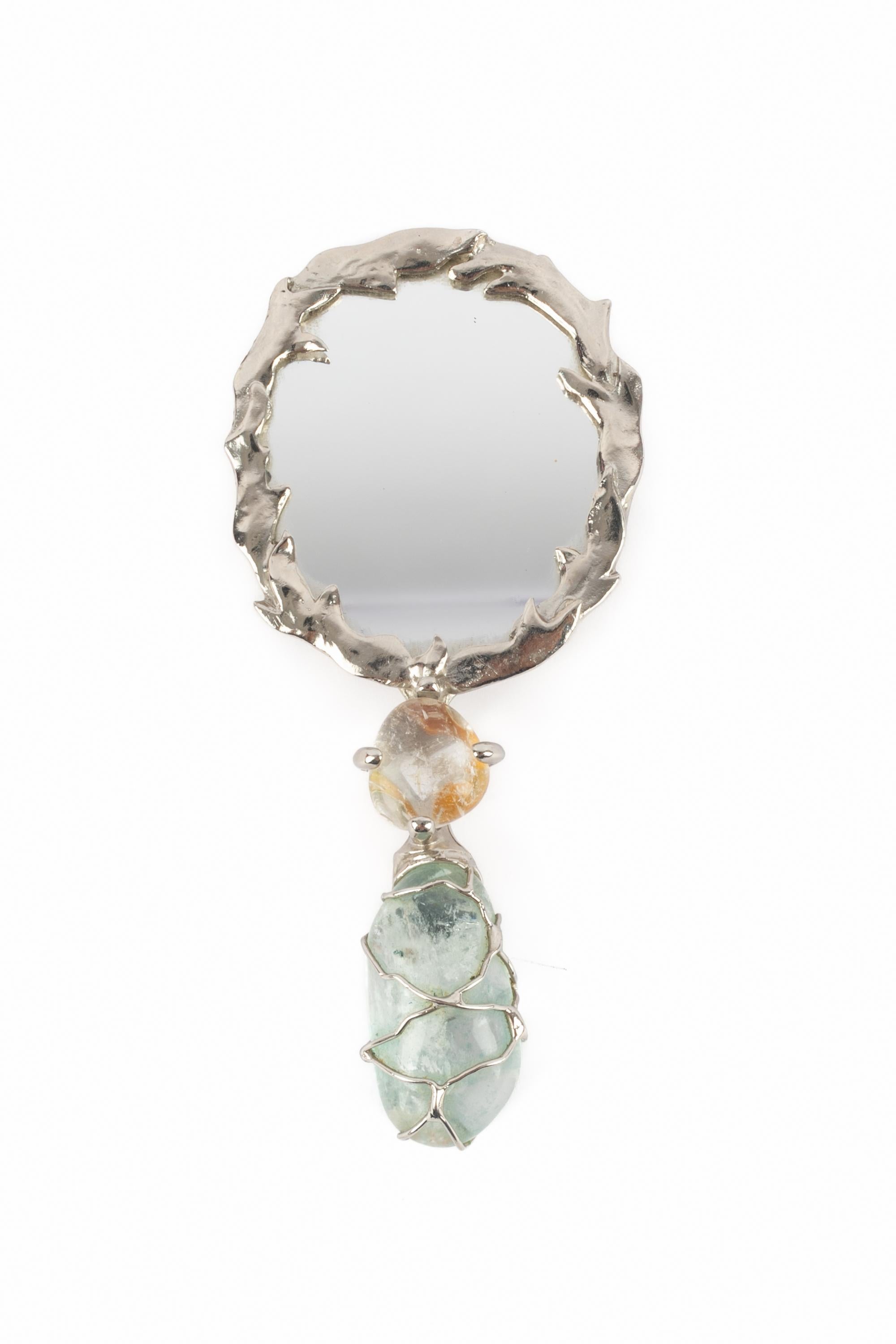 YVES SAINT LAURENT - (Made in France) Silvery metal hand mirror, handle ornamented with colorful stones (quartz). This piece was created on the occasion of the opening of the beauty salon and Haute Couture accessory boutique, Faubourg Saint Honoré