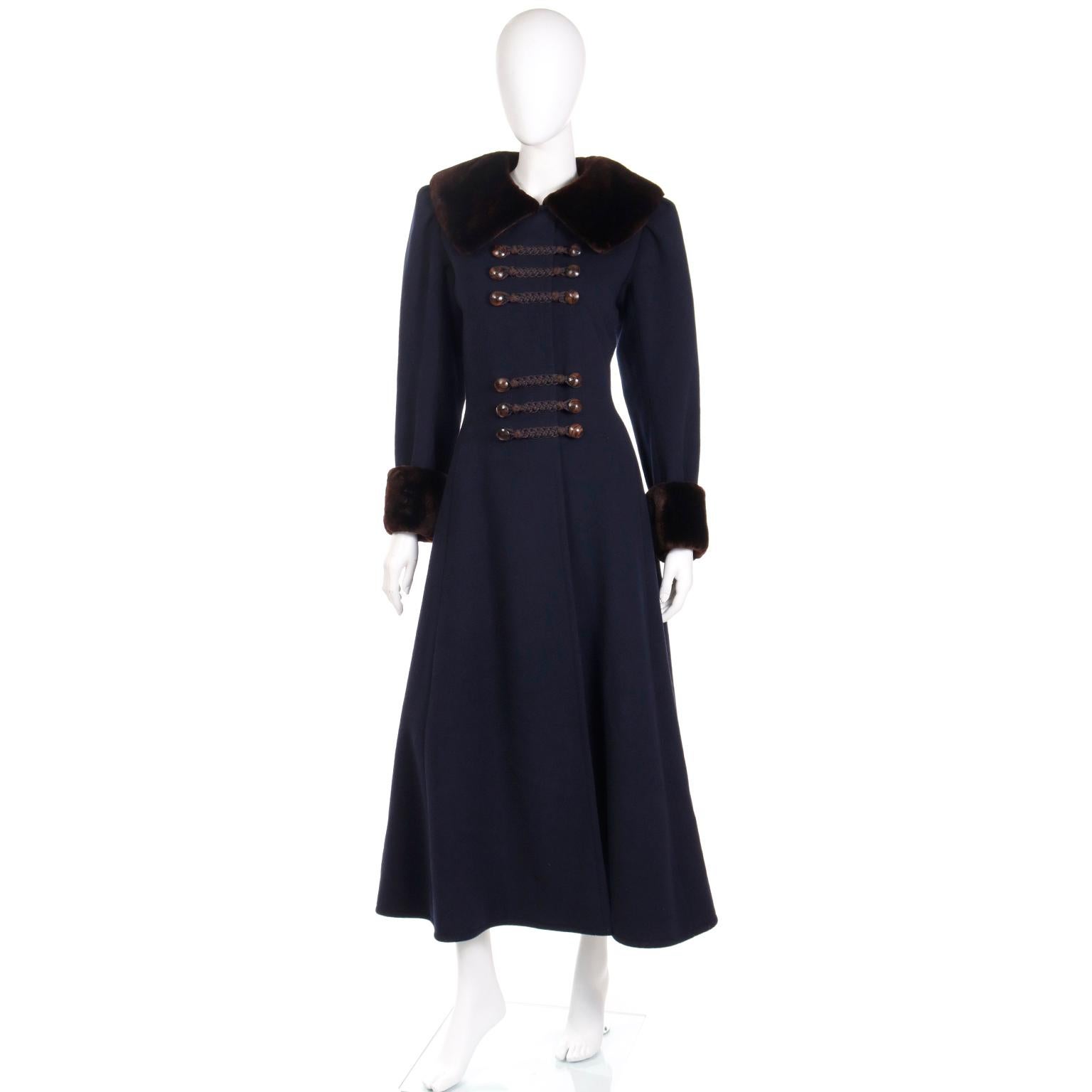 Anyone who knows and loves vintage Yves Saint Laurent fashion will be obsessed with this Haute Couture Fall/Winter 1976 / 77 Cossack style navy blue wool coat with chocolate brown sheared mink trim. This truly iconic coat is a rare, collectible