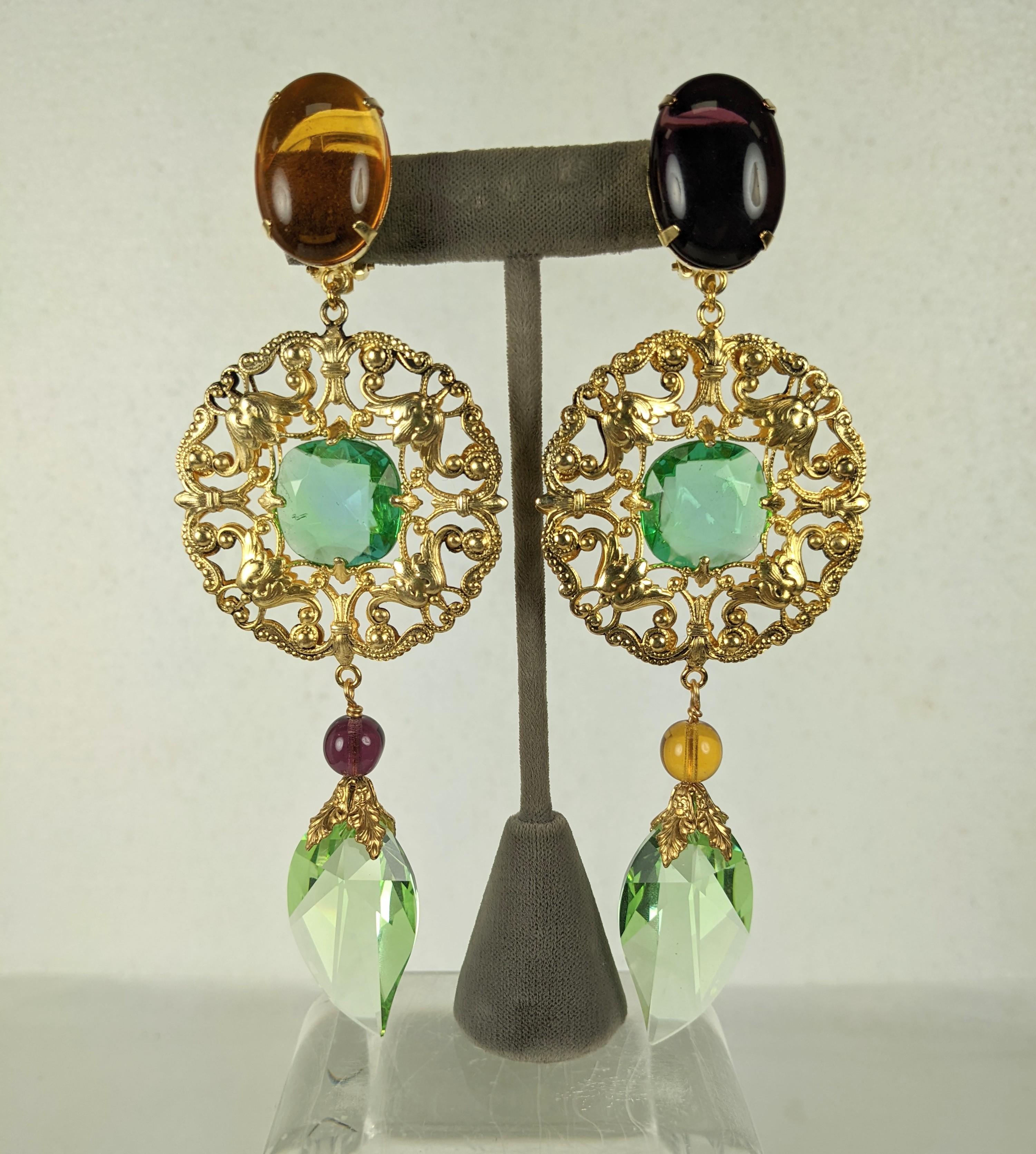 Maison Goossens for Yves Saint Laurent Baroque asymmetric long imposing earrings of ornate gold plated filigree, amythest and topaz pate de verre beads and oval cabochons with cut crystals of green peridot with faceted leaf shaped Swarovski