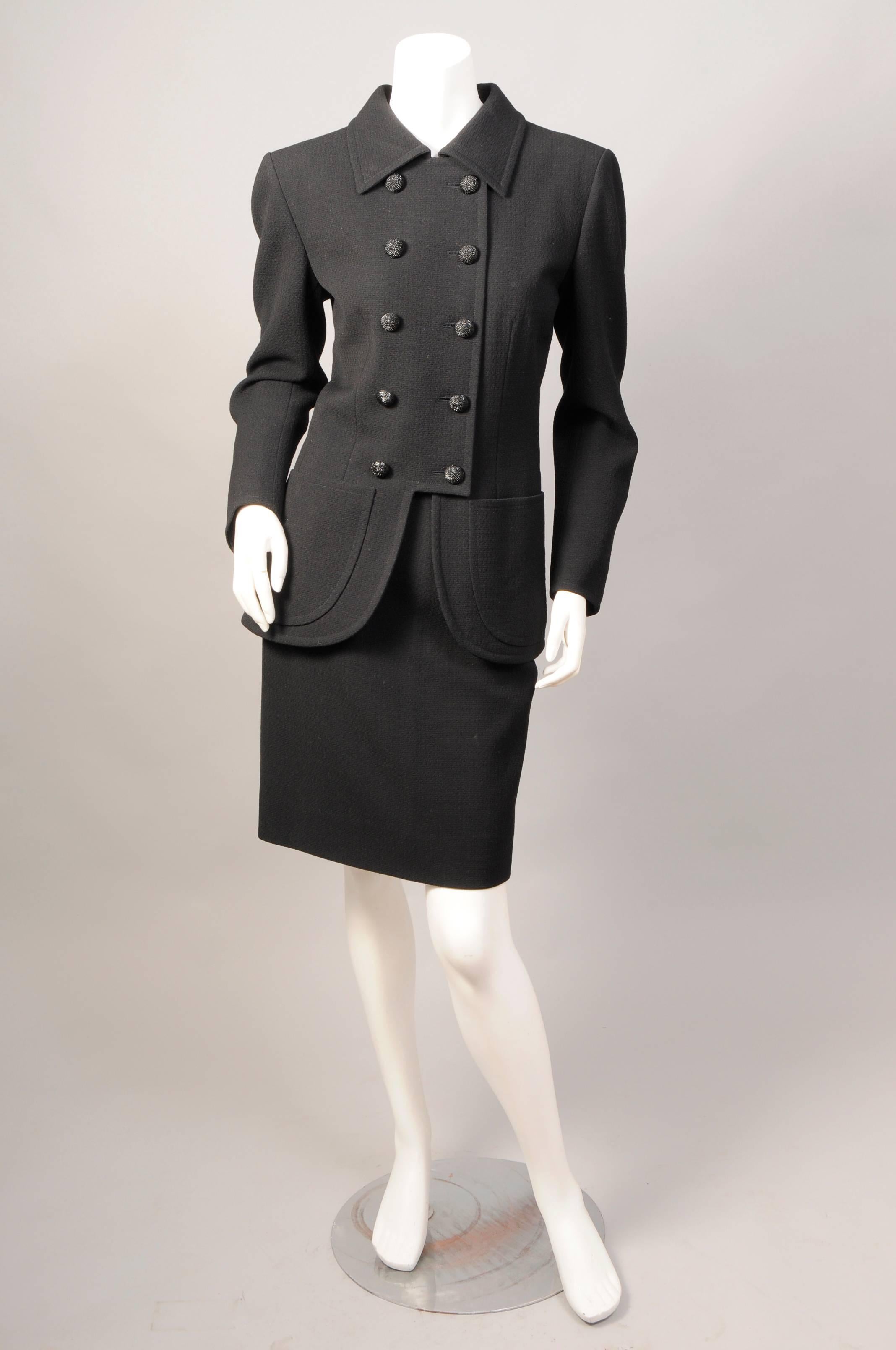 This late 1970's or very early 1980's black wool suit from Yves Saint Laurent  Haute Couture is a stunning example of true French couture tailoring. Made in the YSL atelier in Paris the suit has a great deal of hand finishing in the couture manner.