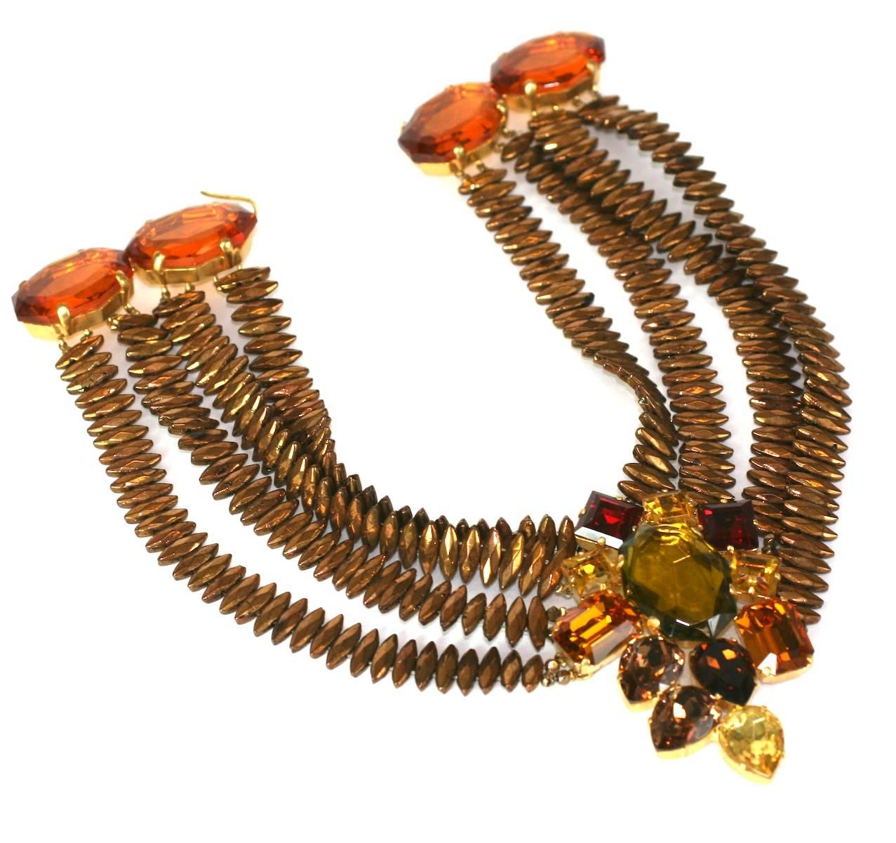 Exceptional Yves Saint Laurent  Haute Couture necklace. The collar is composed of four strands of deep gold flashed victorian marquise jets. The focal asymetrical pendant of faceted vari cut faux garnet, warm topaz and citrines set in gilt metal.