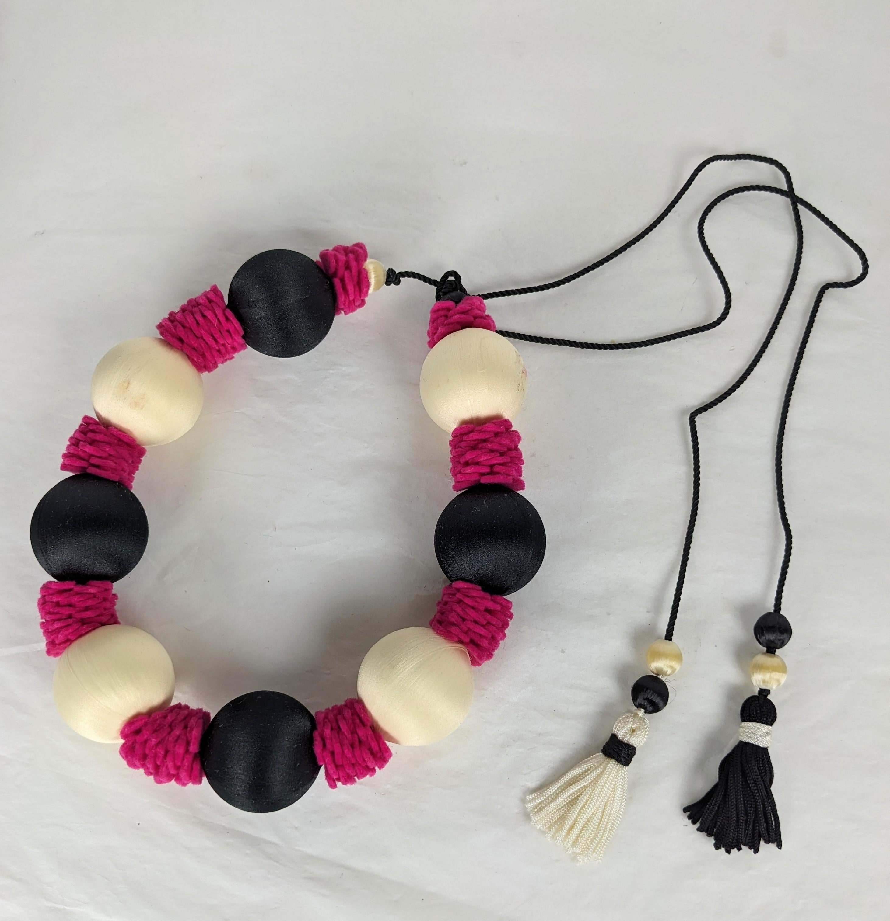 Yves Saint Laurent  Passementerie Necklace , Haute Couture Spring Summer 1977 Spanish Collection. Composed of large and small silk sateen white and black beads and bright shocking pink felted wool. Silk cord ties with tassel ends. Excellent