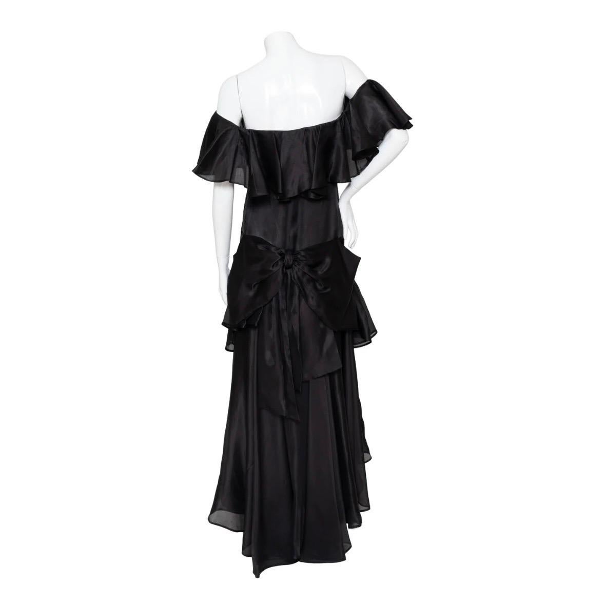 Haute Couture Ruffled Gown by Yves Saint Laurent 
Circa 1980s
Off shoulder with ruffle overlay
Drop waist with ruffle detail
Oversized bow on back
Semisheer 
High low a-line silhouette
Front seams
Size zipper closure
Serial Number: 52788 on
