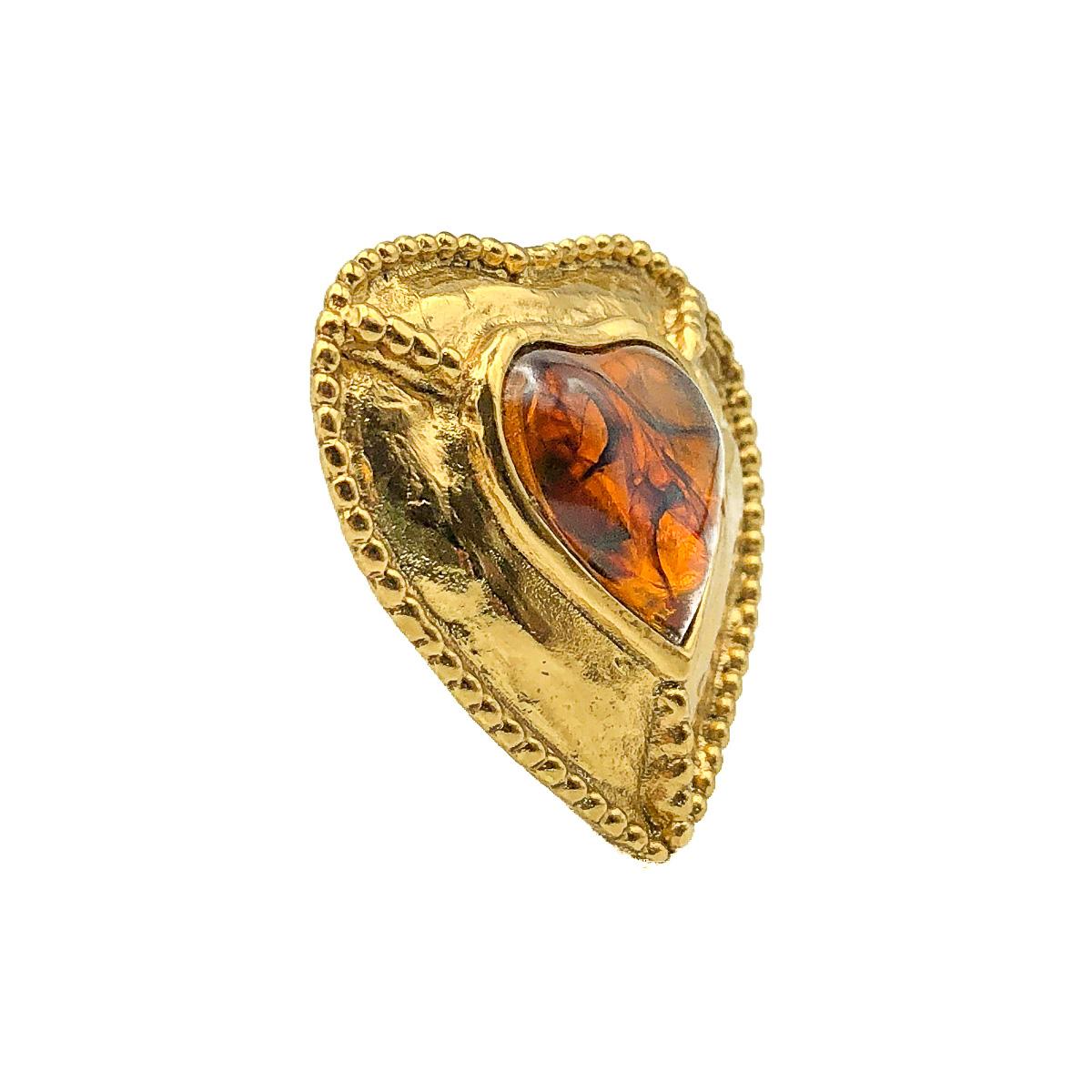 A wonderful Yves Saint Laurent Heart Pendant. Crafted in gold plated metal and set with a large amber style resin heart. The heart, the symbol of the House of Yves Saint Laurent since the 1960s is the most perfect expression of YSL style and design.