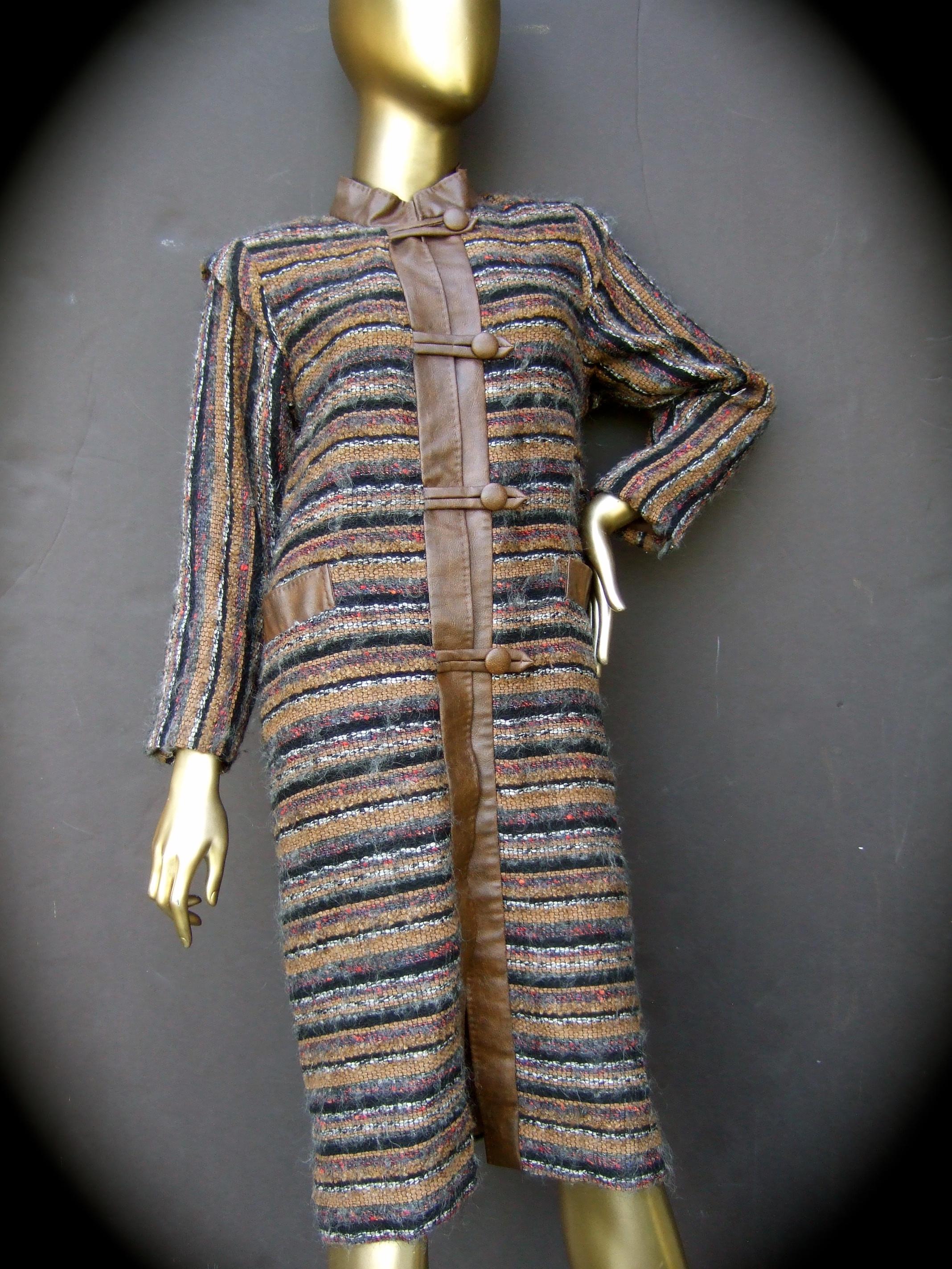 Yves Saint Laurent Horizontal striped fuzzy wool knit women's coat c 1970s
The stylish retro coat is designed with horizontal striped chunky wool
knit in earth tone colors. The sleeves in contrast are designed with vertical 
wool knit stripes